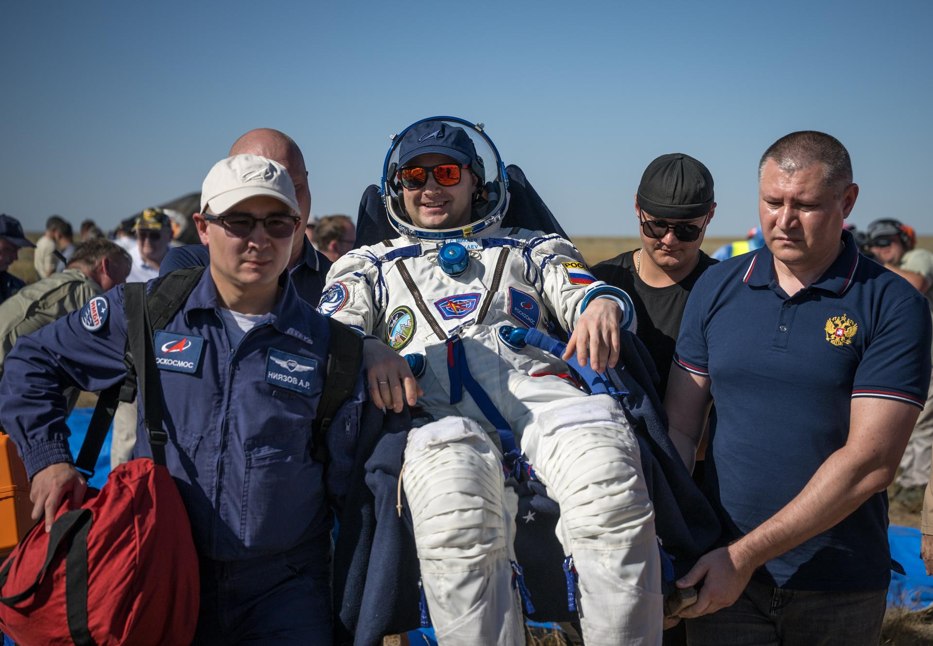 Roscosmos cosmonaut Sergei Mikaev is carried to a medical tent shortly after he, Roscosmos cosmonaut Sergey Kud-Sverchkov, and NASA astronaut Chris Williams landed in their Soyuz MS-28 spacecraft near the town of Zhezkazgan, Kazakhstan on Sunday, July 26, 2026. The trio returned to Earth after logging 241 days in space as a members of Expeditions 73 and 74 aboard the International Space Station. Photo Credit: (NASA/Bill Ingalls)