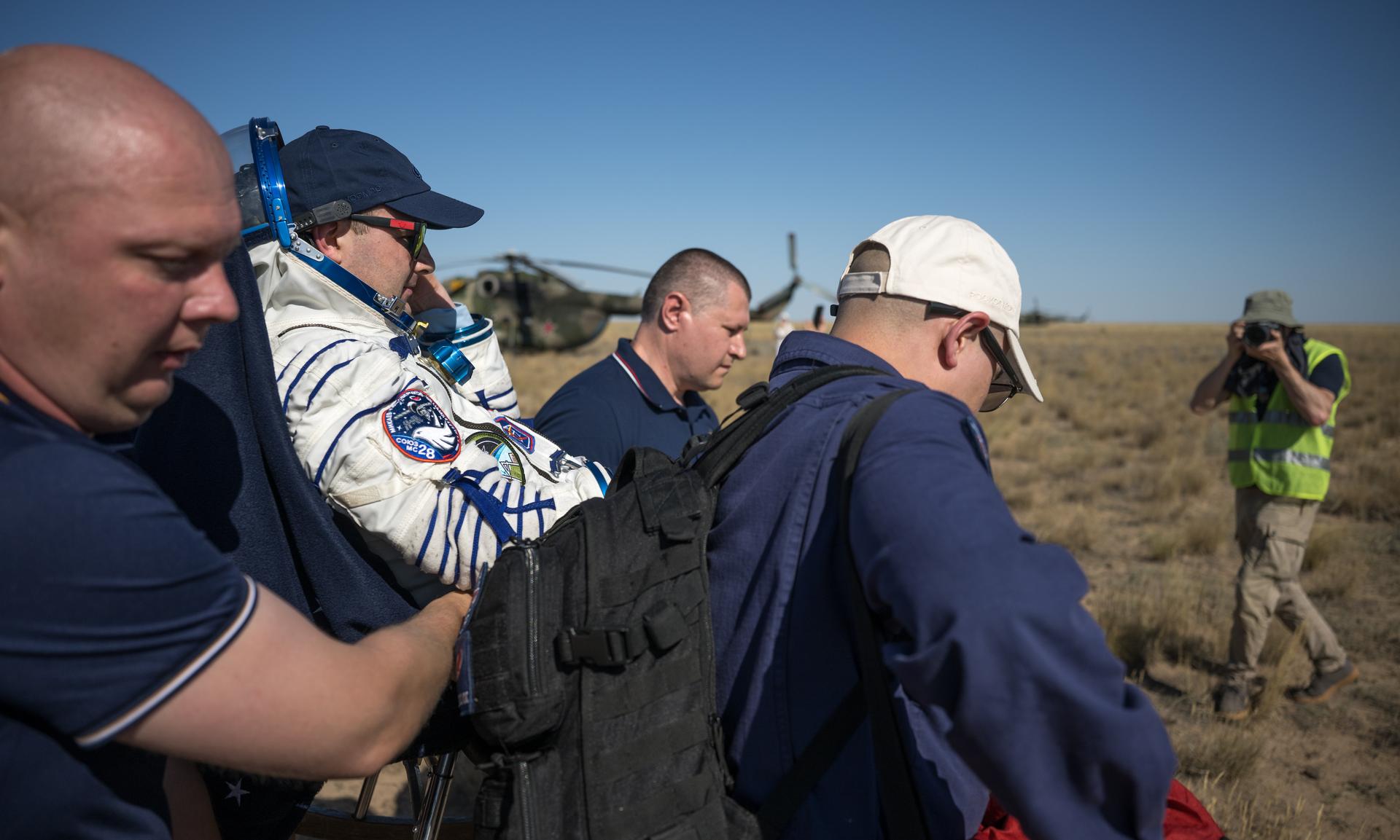 Roscosmos cosmonaut Sergei Mikaev is carried to a medical tent shortly after he, Roscosmos cosmonaut Sergey Kud-Sverchkov, and NASA astronaut Chris Williams landed in their Soyuz MS-28 spacecraft near the town of Zhezkazgan, Kazakhstan on Sunday, July 26, 2026. The trio returned to Earth after logging 241 days in space as a members of Expeditions 73 and 74 aboard the International Space Station. Photo Credit: (NASA/Bill Ingalls)