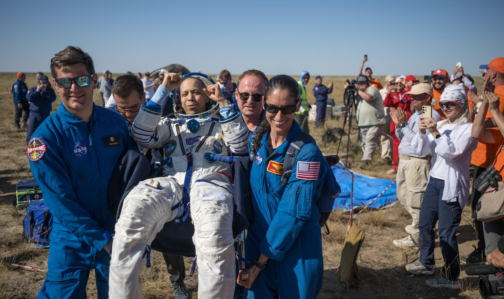 NASA astronaut Chris Williams is carried to a medical tent shortly after he and Roscosmos cosmonauts Sergey Kud-Sverchkov, and Sergei Mikaev landed in their Soyuz MS-28 spacecraft near the town of Zhezkazgan, Kazakhstan on Sunday, July 26, 2026. The trio returned to Earth after logging 241 days in space as a members of Expeditions 73 and 74 aboard the International Space Station. Photo Credit: (NASA/Bill Ingalls)