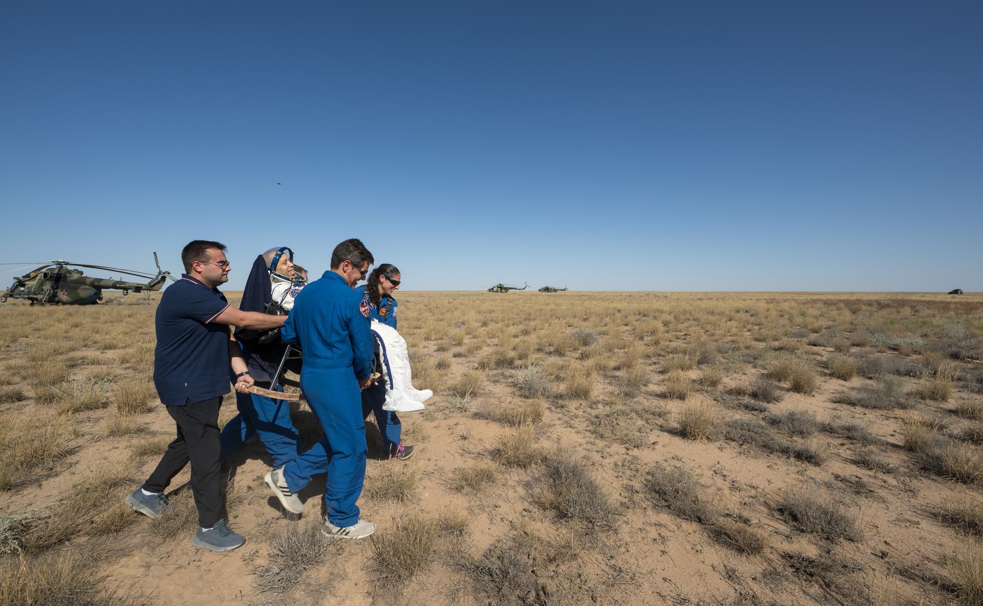 NASA astronaut Chris Williams is carried to a medical tent shortly after he and Roscosmos cosmonauts Sergey Kud-Sverchkov, and Sergei Mikaev landed in their Soyuz MS-28 spacecraft near the town of Zhezkazgan, Kazakhstan on Sunday, July 26, 2026. The trio returned to Earth after logging 241 days in space as a members of Expeditions 73 and 74 aboard the International Space Station. Photo Credit: (NASA/Bill Ingalls)