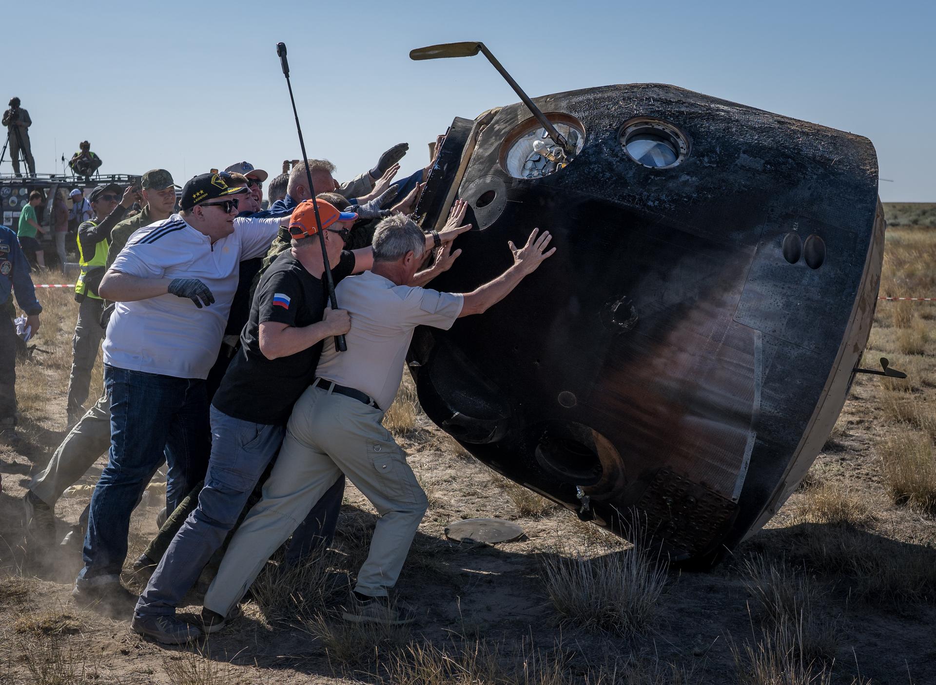 Russian support personnel raise the Soyuz MS-28 spacecraft shortly after it landed in a remote area near the town of Zhezkazgan, Kazakhstan with Expedition 74 NASA astronaut Chris Williams, and Roscosmos cosmonauts Sergey Kud-Sverchkov, and Sergei Mikaev aboard, Sunday, July 26, 2026. The trio returned to Earth after logging 241 days in space as a members of Expeditions 73 and 74 aboard the International Space Station. Photo Credit: (NASA/Bill Ingalls)