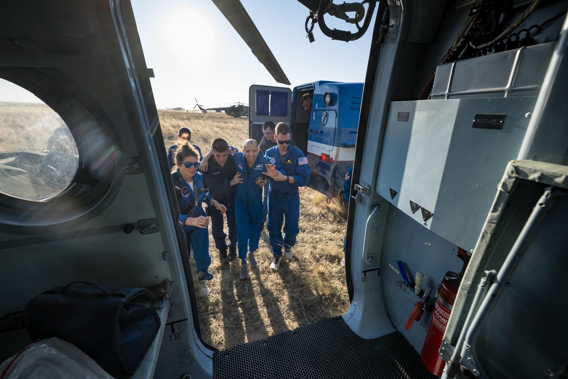 NASA astronaut Chris Williams is helped onboard a Russian MI-8 Helicopter after he, Roscosmos cosmonauts Sergey Kud-Sverchkov, and Sergei Mikaev landed in their Soyuz MS-28 spacecraft near the town of Zhezkazgan, Kazakhstan on Sunday, July 26, 2026. The trio returned to Earth after logging 241 days in space as a members of Expeditions 73 and 74 aboard the International Space Station. Photo Credit: (NASA/Bill Ingalls)