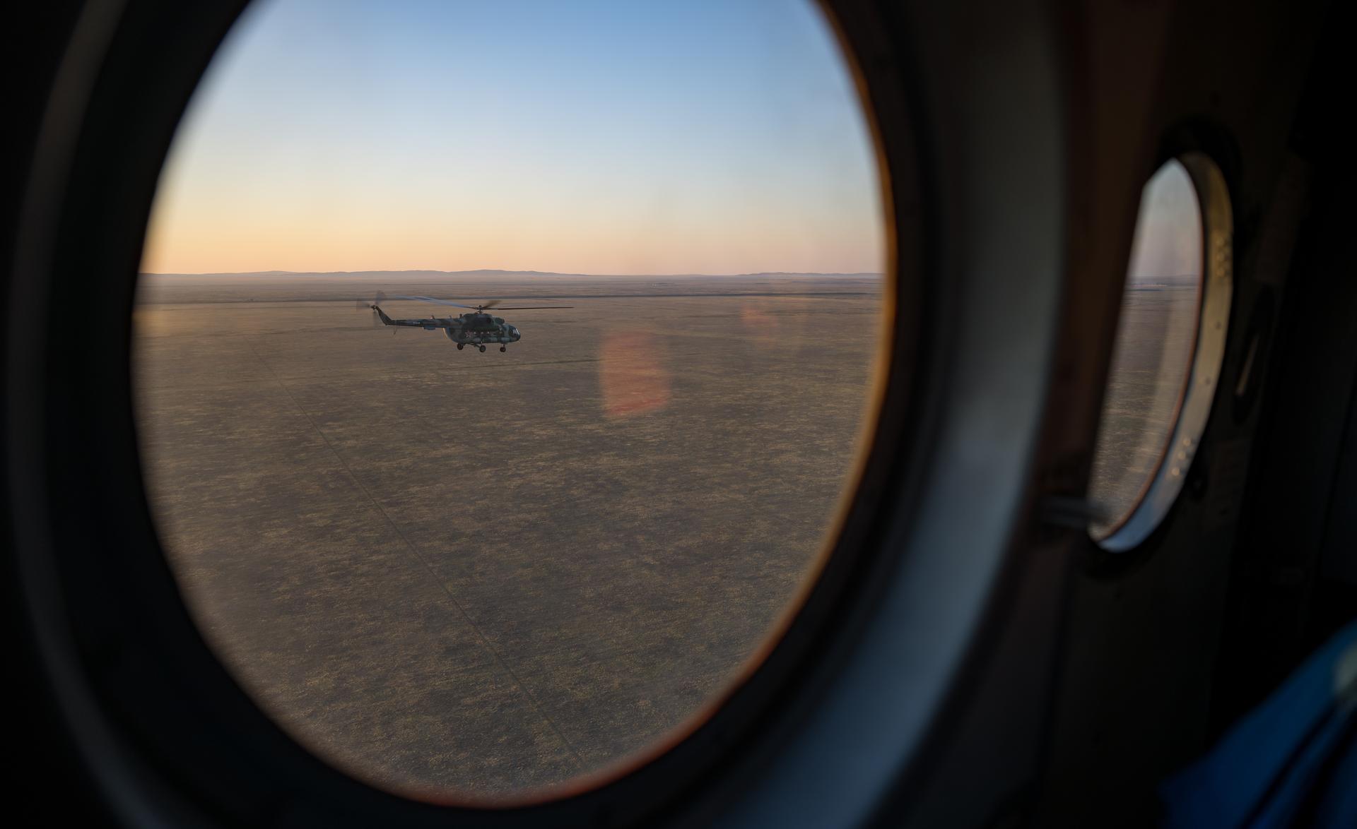 Helicopters depart the Soyuz MS-28 spacecraft landing site in a remote area near the town of Zhezkazgan, Kazakhstan after the landing of Expedition 74 NASA astronaut Chris Williams, and Roscosmos cosmonauts Sergey Kud-Sverchkov, and Sergei Mikaev, Sunday, July 26, 2026. The trio returned to Earth after logging 241 days in space as members of Expeditions 73 and 74 aboard the International Space Station. Photo Credit: (NASA/Bill Ingalls)
