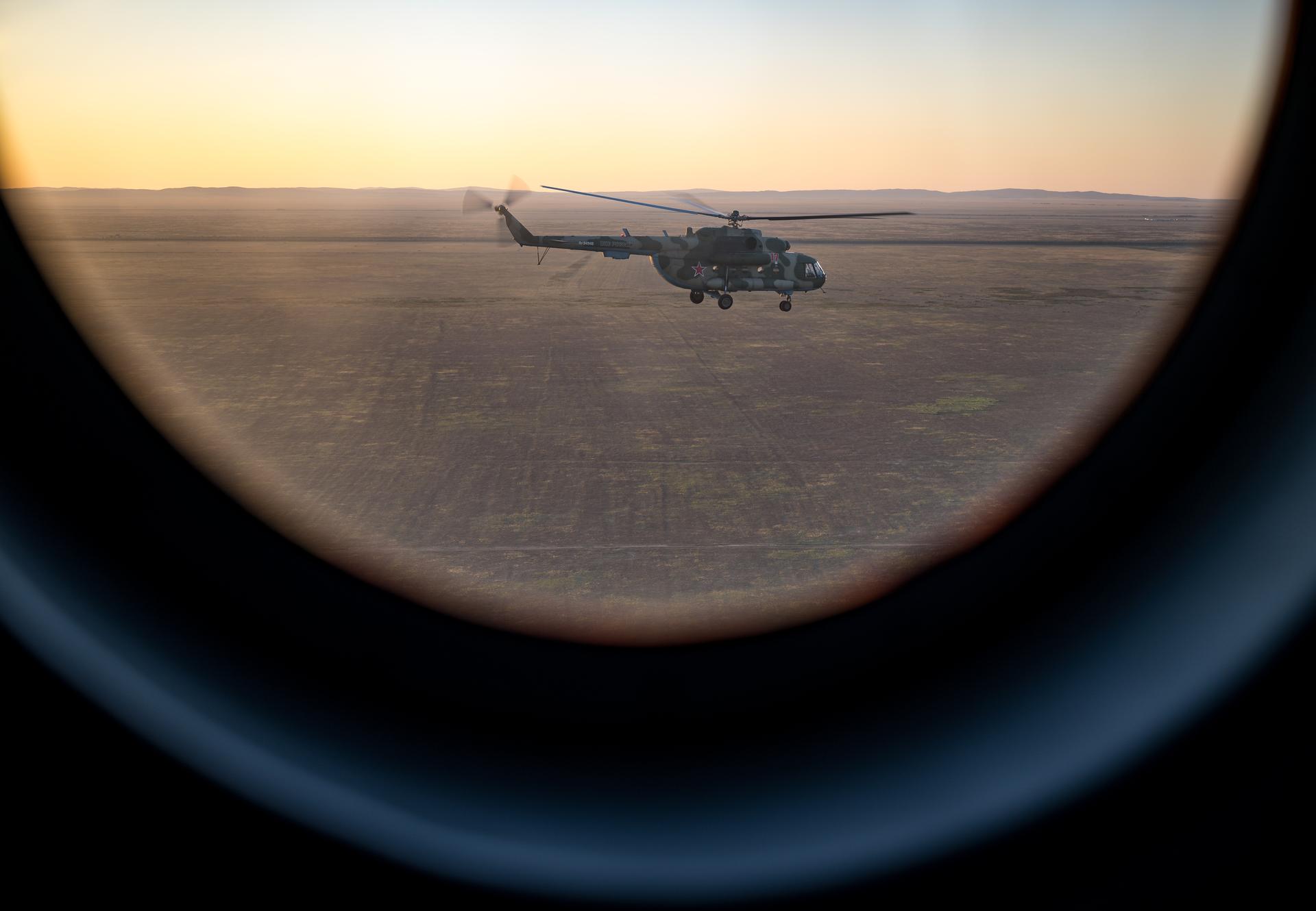 Helicopters depart the Soyuz MS-28 spacecraft landing site in a remote area near the town of Zhezkazgan, Kazakhstan after the landing of Expedition 74 NASA astronaut Chris Williams, and Roscosmos cosmonauts Sergey Kud-Sverchkov, and Sergei Mikaev, Sunday, July 26, 2026. The trio returned to Earth after logging 241 days in space as members of Expeditions 73 and 74 aboard the International Space Station. Photo Credit: (NASA/Bill Ingalls)