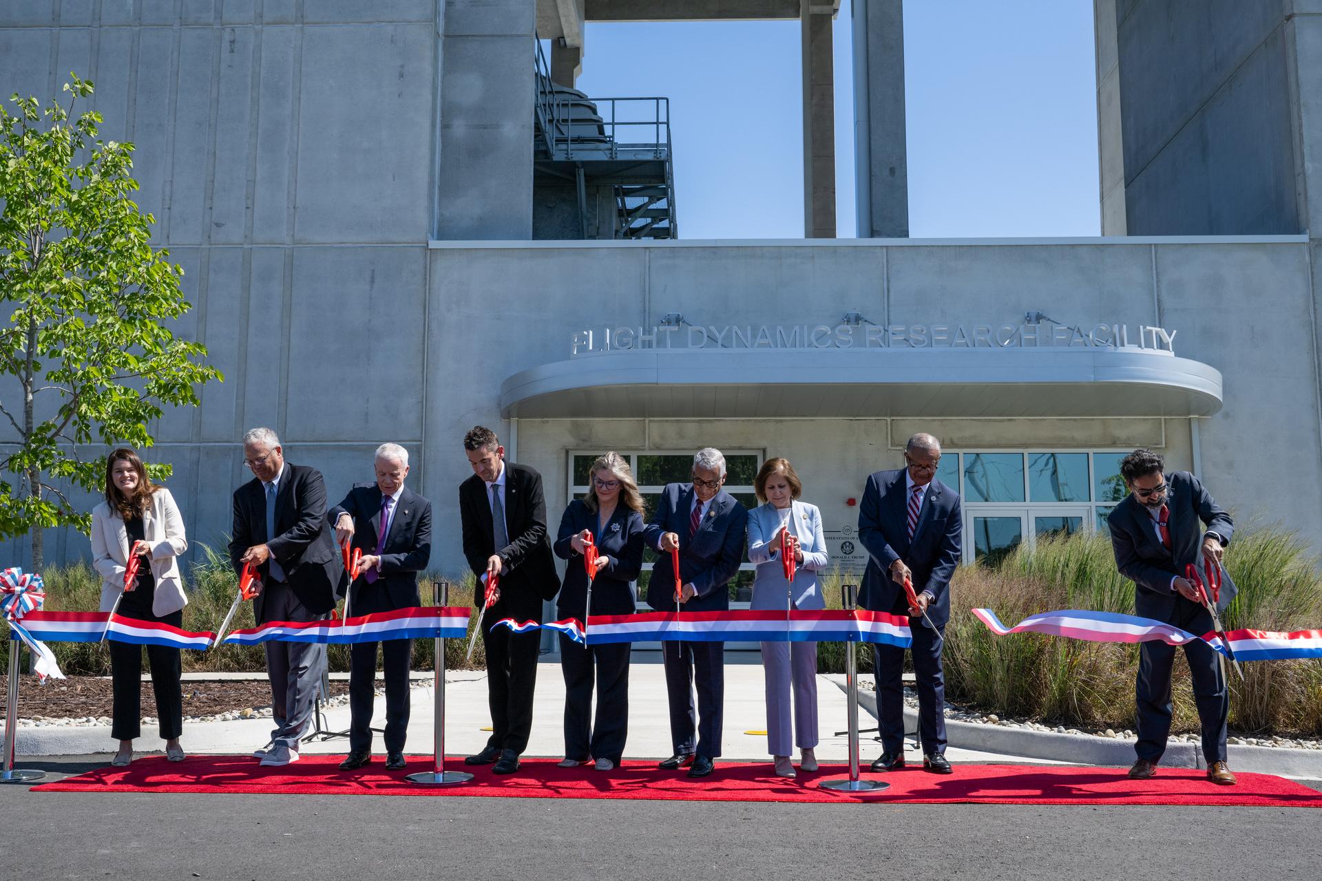From left to right, Casey Swails, NASA Deputy Associate Administrator, Mike Waller, Vice President of BL Harbert International Federal Division, Edward C. Forst, Administrator of the General Services Administration, NASA Administrator Jared Isaacman, Dr. Trina Dyal, director of NASA's Langley Research Center, Congressman Robert “Bobby” Scott (D-Va.), Virginia Lt. Governor Ghazala F. Hashmi, City of Hampton Mayor Jimmy Gray, and Amit Kshatriya, NASA Associate Administrator cut the ribbon to open the Flight Dynamics Research Facility, NASA's newest wind tunnel, Friday, July 31, 2026, at NASA’s Langley Research Center in Hampton, Virginia. The state-of-the-art facility will support research and technology development that will advance the agency’s aeronautics, exploration, and science goals, including establishing a sustained human presence on the lunar surface through the Artemis program and the development of a Moon Base. Photo Credit: (NASA/Keegan Barber)