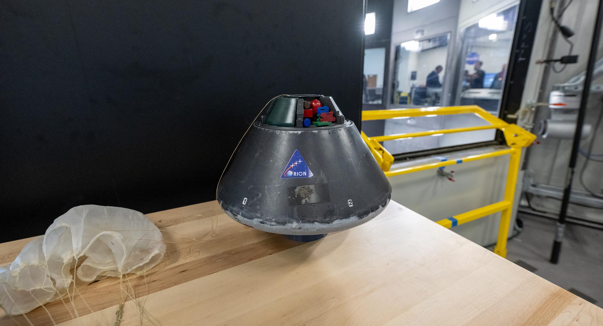A scale model of the Orion capsule is seen prior to a demonstration at the Flight Dynamics Research Facility, NASA's newest wind tunnel, Friday, July 31, 2026, at NASA’s Langley Research Center in Hampton, Virginia. The state-of-the-art facility will support research and technology development that will advance the agency’s aeronautics, exploration, and science goals, including establishing a sustained human presence on the lunar surface through the Artemis program and the development of a Moon Base. Photo Credit: (NASA/Keegan Barber)