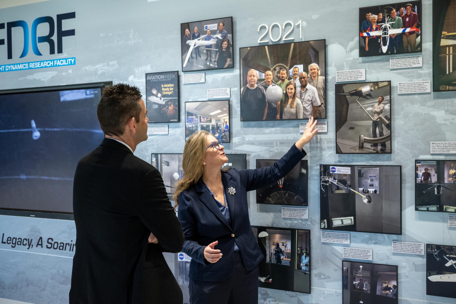 Dr. Trina Dyal, director of NASA's Langley Research Center, right, shows NASA Administrator Jared Isaacman, left, a historical photo during a tour of the Flight Dynamics Research Facility, NASA's newest wind tunnel, Friday, July 31, 2026, at NASA’s Langley Research Center in Hampton, Virginia. The state-of-the-art facility will support research and technology development that will advance the agency’s aeronautics, exploration, and science goals, including establishing a sustained human presence on the lunar surface through the Artemis program and the development of a Moon Base. Photo Credit: (NASA/Keegan Barber)