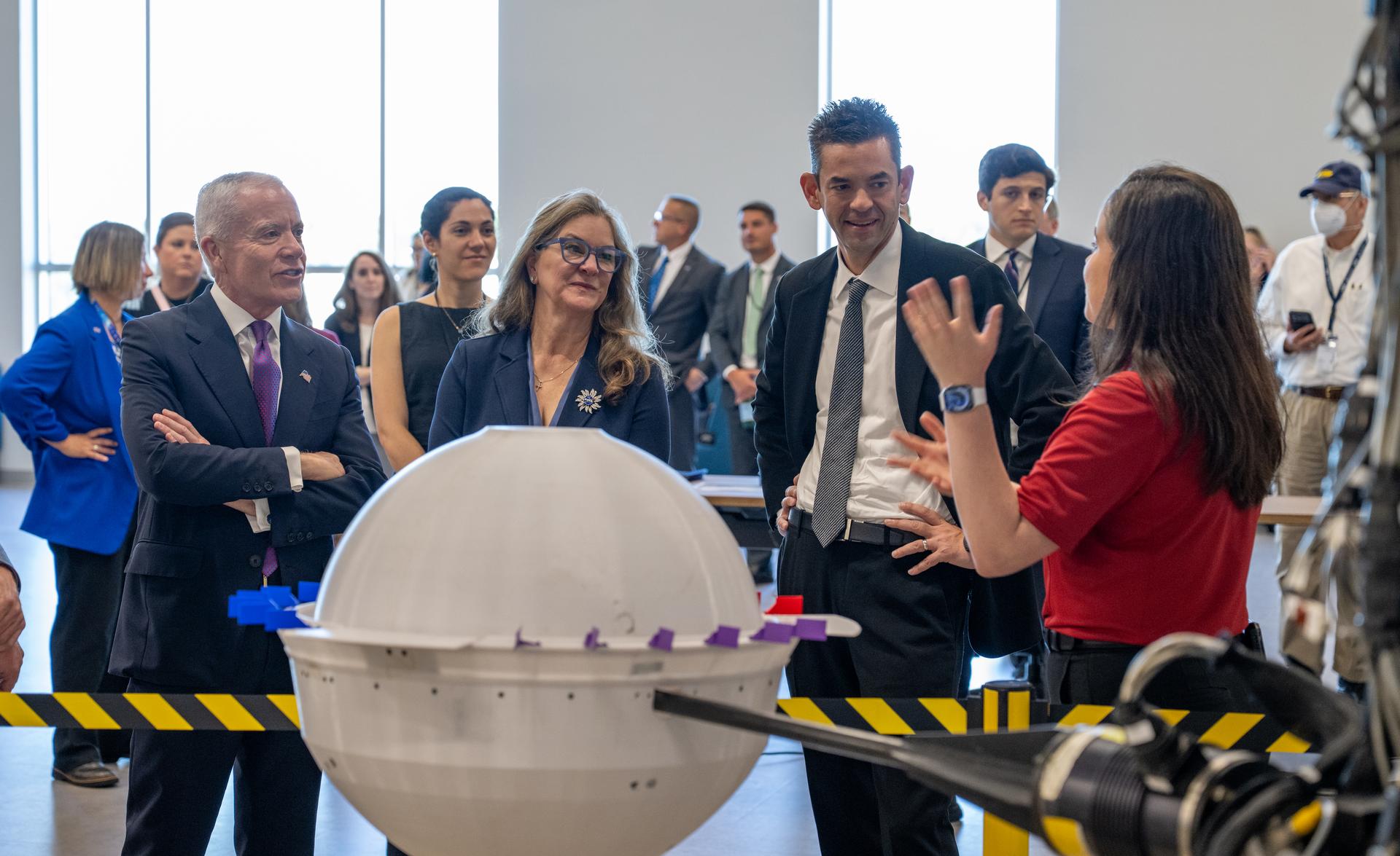 Hayden Dean, senior aerospace engineer, speaks with, from left to right, Edward C. Forst, Administrator of the General Services Administration, Dr. Trina Dyal, director of NASA's Langley Research Center, and NASA Administrator Jared Isaacman, about a test model of NASA’s Deep Atmosphere Venus Investigation of Noble gases, Chemistry, and Imaging (DAVINCI) descent probe during a tour of the Flight Dynamics Research Facility, NASA's newest wind tunnel, Friday, July 31, 2026, at NASA’s Langley Research Center in Hampton, Virginia. The state-of-the-art facility will support research and technology development that will advance the agency’s aeronautics, exploration, and science goals, including establishing a sustained human presence on the lunar surface through the Artemis program and the development of a Moon Base. Photo Credit: (NASA/Keegan Barber)