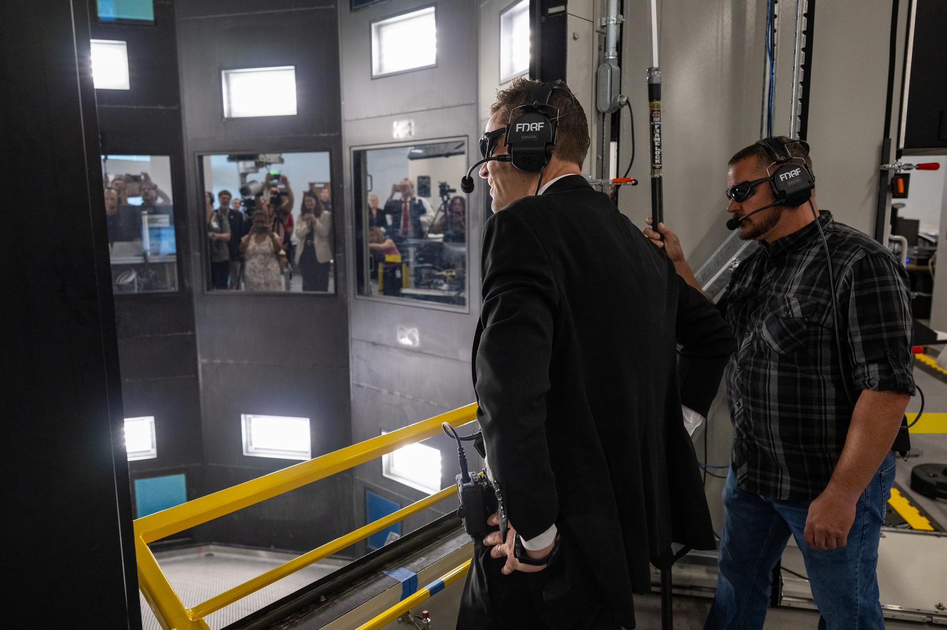 NASA Administrator Jared Isaacman, left, joined by Rick Thorpe, equipment specialist, right, is seen after launching a scale model of the Orion capsule during a demonstration at the Flight Dynamics Research Facility, NASA's newest wind tunnel, Friday, July 31, 2026, at NASA’s Langley Research Center in Hampton, Virginia. The state-of-the-art facility will support research and technology development that will advance the agency’s aeronautics, exploration, and science goals, including establishing a sustained human presence on the lunar surface through the Artemis program and the development of a Moon Base. Photo Credit: (NASA/Keegan Barber)