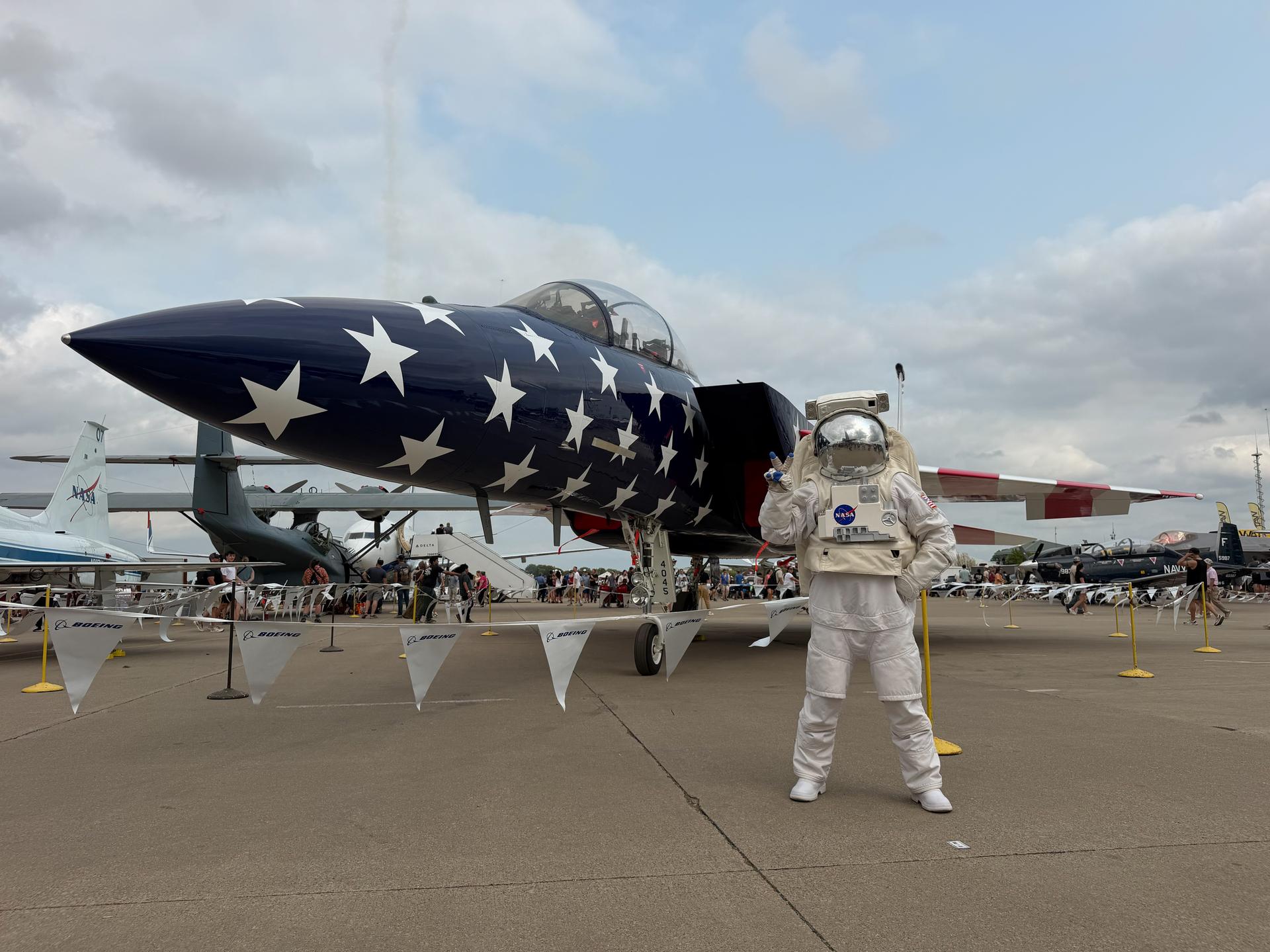 NASA’s Spacey Casey poses in front of NASA’s F-15 painted with new red, white, and blue livery to celebrate America’s 250th birthday at the Boeing Plaza at the 2026 Experimental Aircraft Association (EAA) AirVenture air show in Oshkosh, Wisconsin, on Saturday, July 26, 2026.