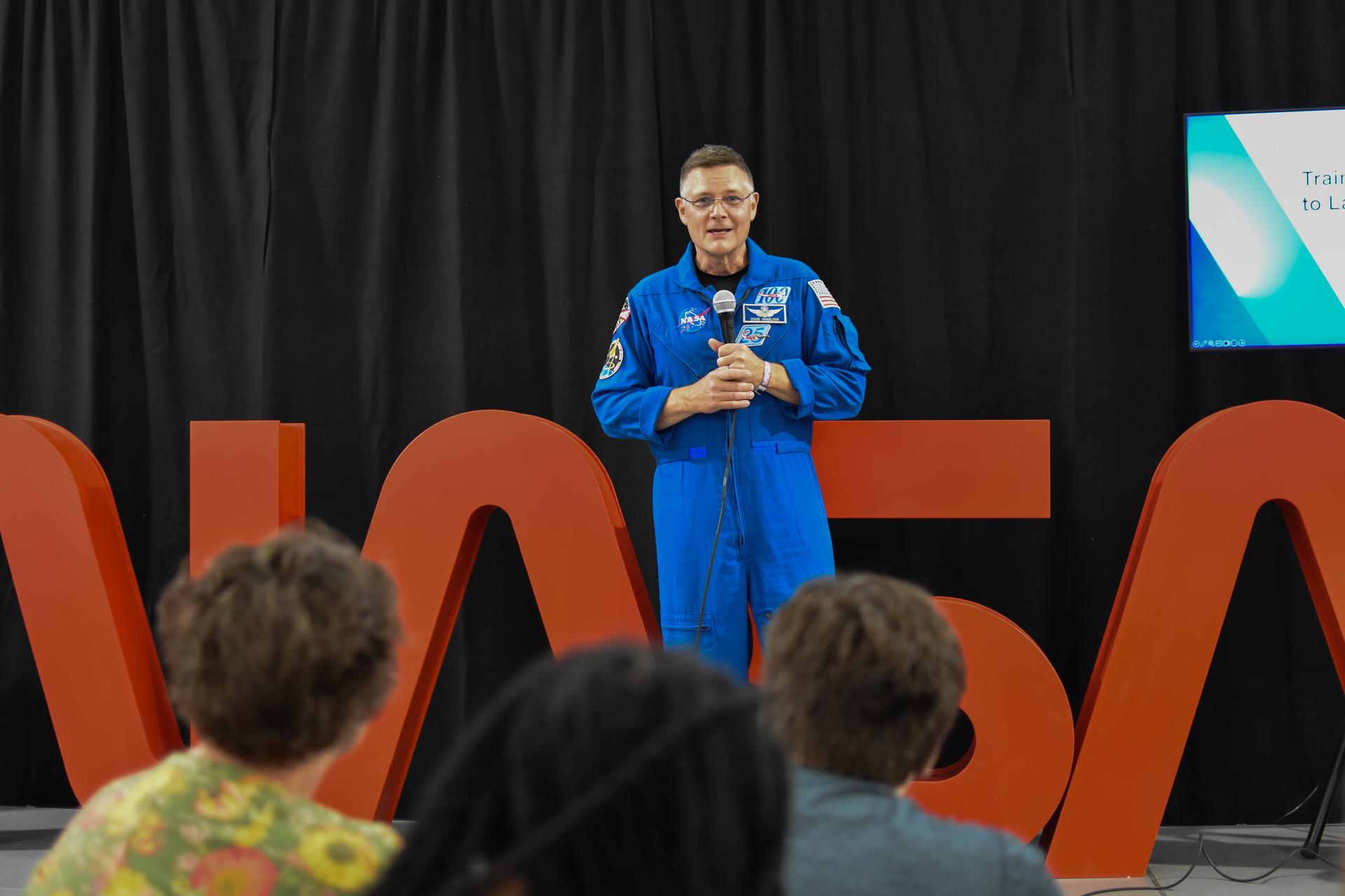 NASA astronaut Doug Weelock speaks at the NASA pavilion during his presentation “Training Artemis Astronauts to Land on the Moon” at the 2026 Experimental Aircraft Association (EAA) AirVenture air show in Oshkosh, Wisconsin, on Tuesday, July 21, 2026.