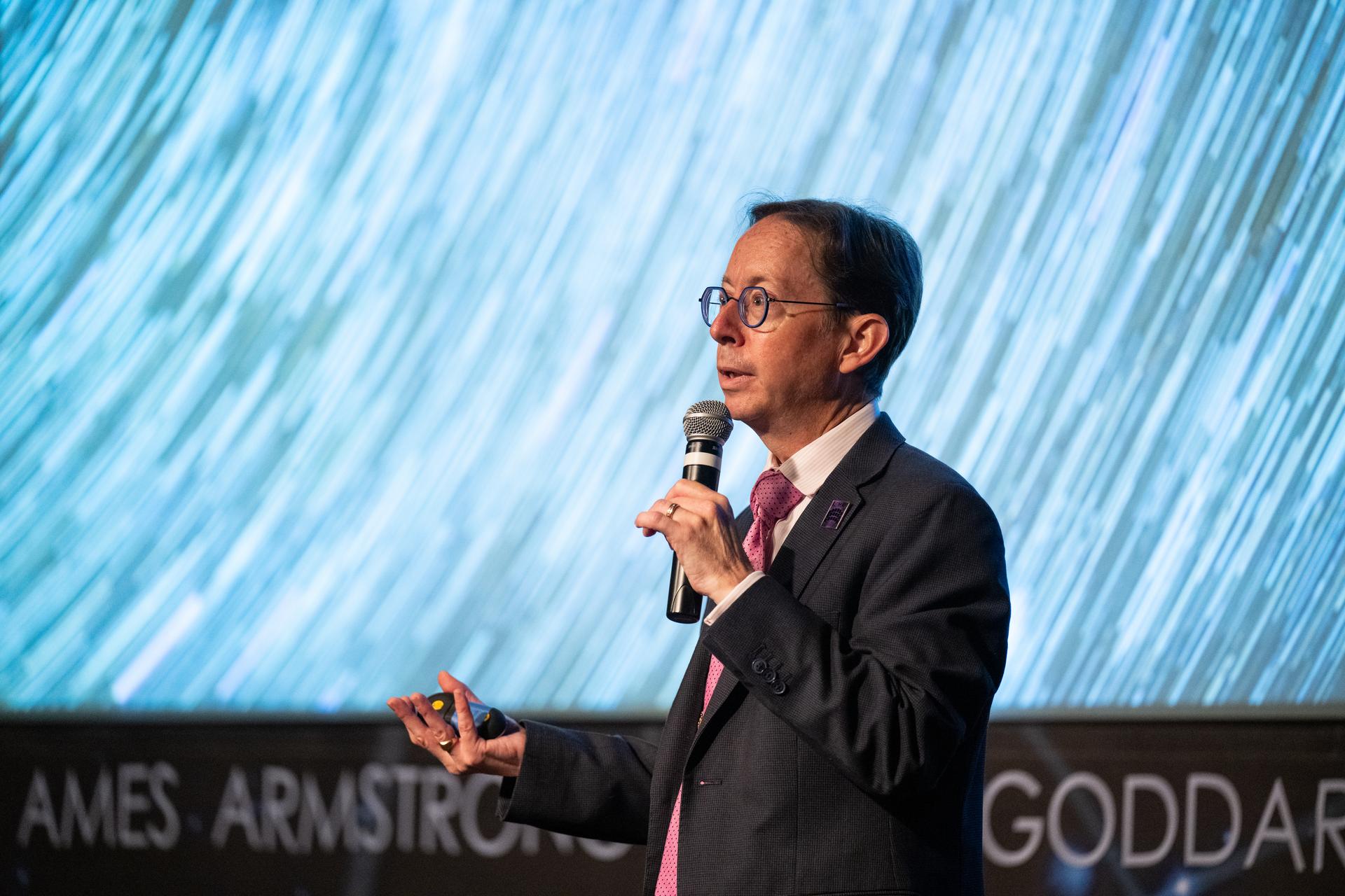 Dr. Dominic Benford, program scientist for the nancy grace roman space telescope, speaks at a Frontiers Forum event titled "Countdown to Launch – Why We’re Excited about the Nancy Grace Roman Space Telescope," Thursday, Aug. 6, 2026, at the Mary W. Jackson NASA Headquarters building in Washington.  Photo Credit: (NASA/Keegan Barber)