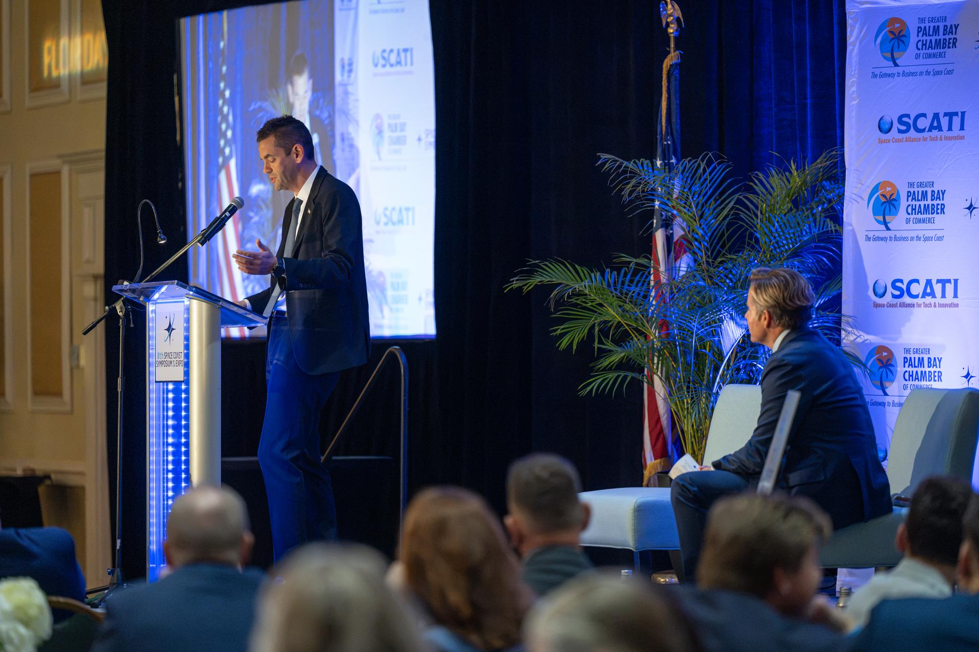 NASA Administrator Jared Isaacman, left, participates in a fireside chat with U.S. Rep. Mike Haridopolos of Florida’s 8th congressional district, right, Friday, Aug. 21, 2026, at the 8th Annual Space Coast Symposium & Expo in Cape Canaveral, Fla. Photo Credit: (NASA/John Kraus)