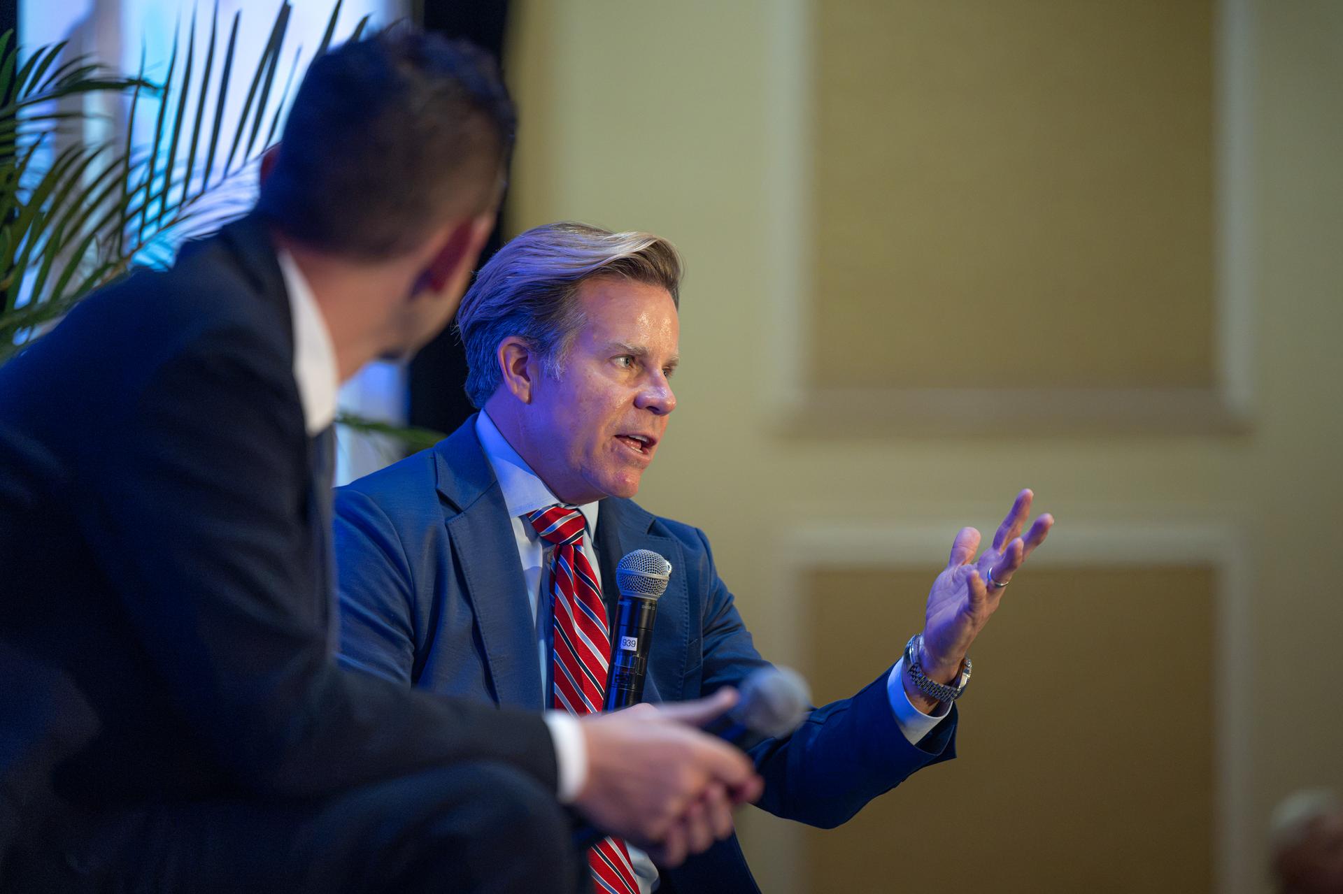NASA Administrator Jared Isaacman, left, participates in a fireside chat with U.S. Rep. Mike Haridopolos of Florida’s 8th congressional district, center, Friday, Aug. 21, 2026, at the 8th Annual Space Coast Symposium & Expo in Cape Canaveral, Fla. Photo Credit: (NASA/John Kraus)