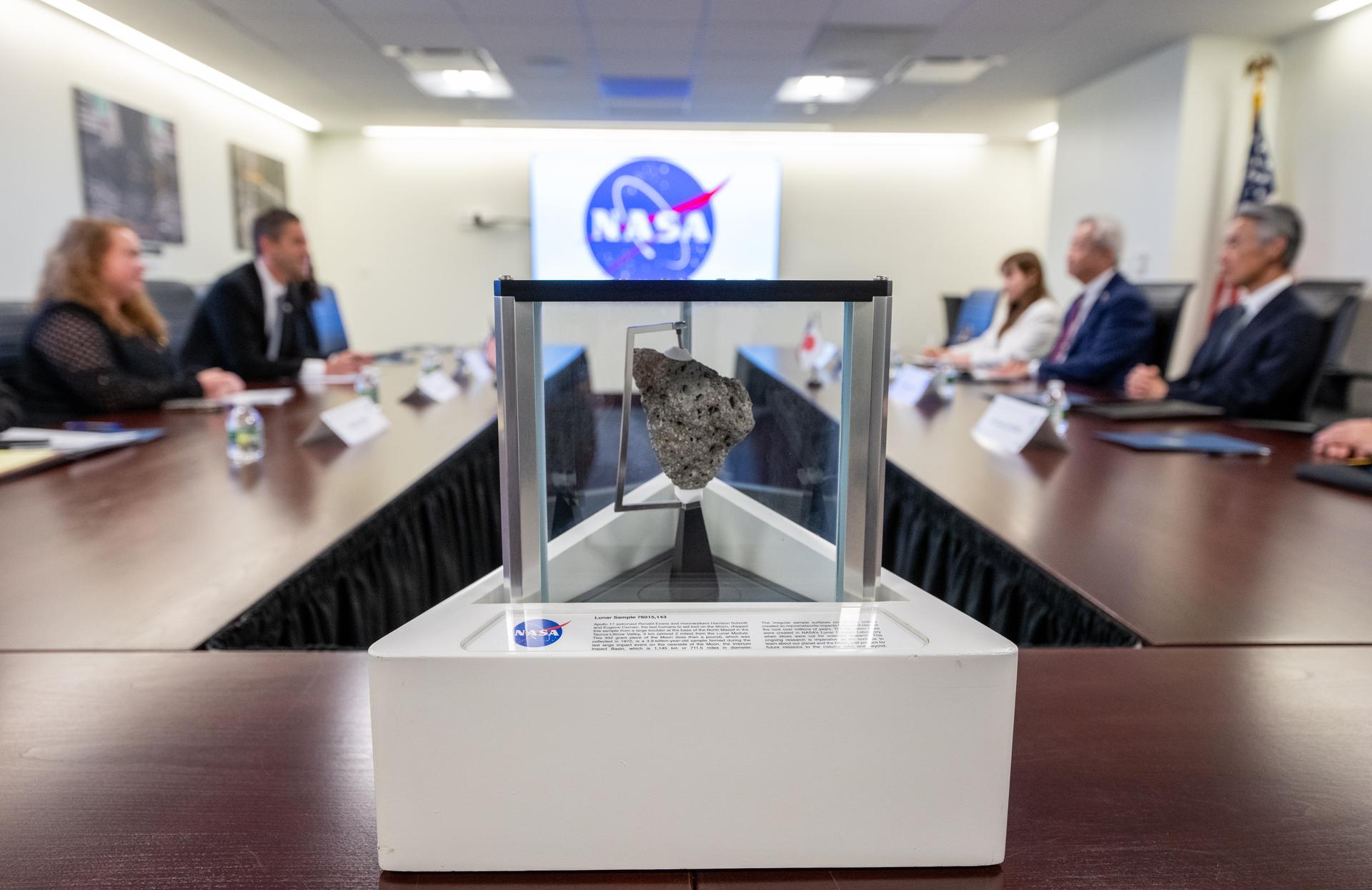 A lunar sample collected during the Apollo 17 mission is seen in the foreground during a meeting between Jun Sawada, Chairman of Japan’s National Space Policy Committee (NSPC), and NASA Administrator Jared Isaacman Monday, Aug. 24, 2026, at the Mary W. Jackson NASA Headquarters building in Washington. Photo Credit: (NASA/Keegan Barber)