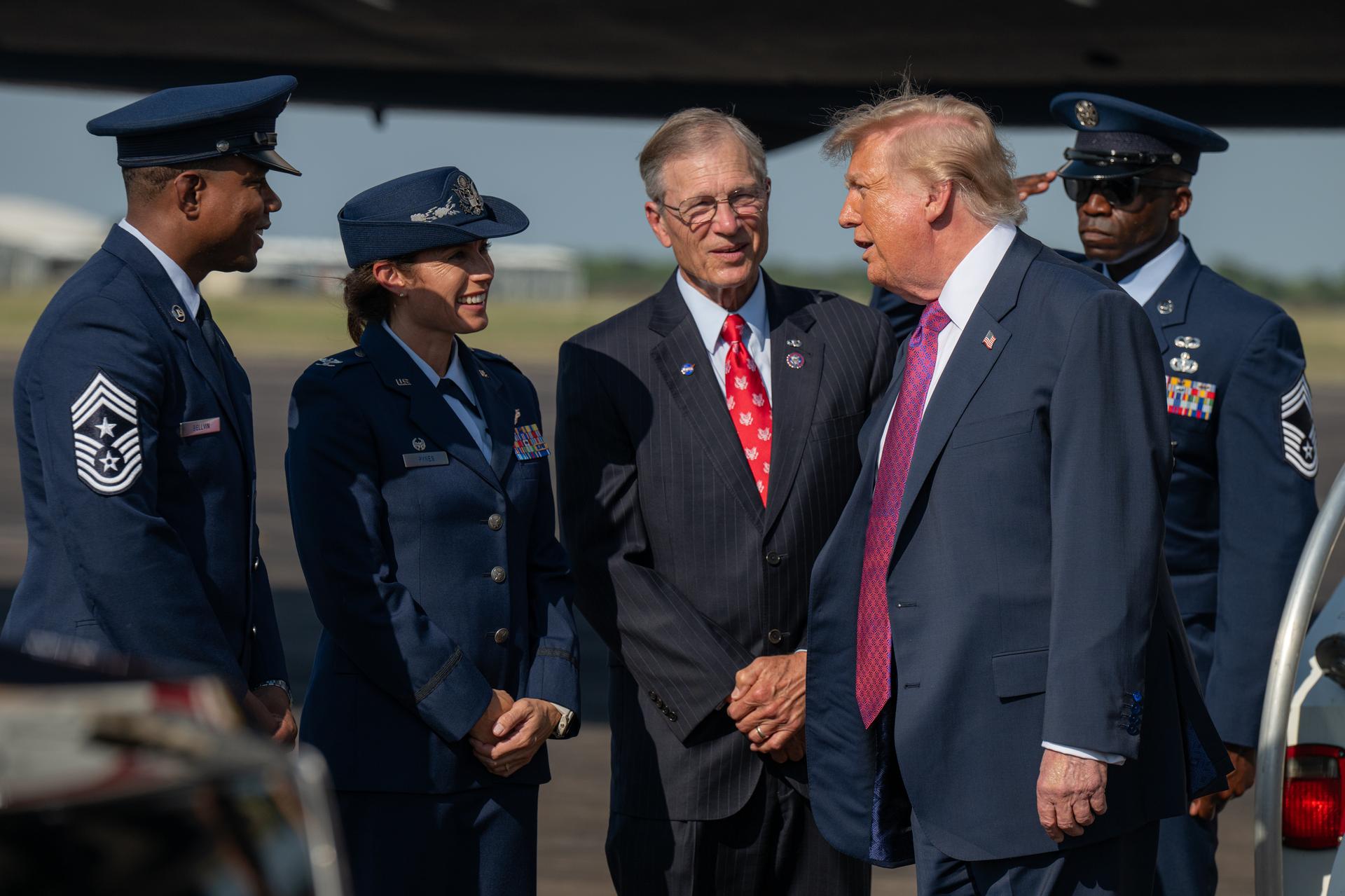 President Donald Trump speaks with members of the U.S. Air Force and U.S. Representative Brian Babin of Texas's 36th congressional district after disembarking Air Force One, Thursday, Aug. 27, 2026, at Ellington Field Joint Reserve Base in Houston, Texas. President Trump is visiting NASA’s Johnson Space Center to award the Congressional Space Medal of Honor to the Artemis II crew on Friday, Aug. 28. Photo Credit: (NASA/John Kraus)