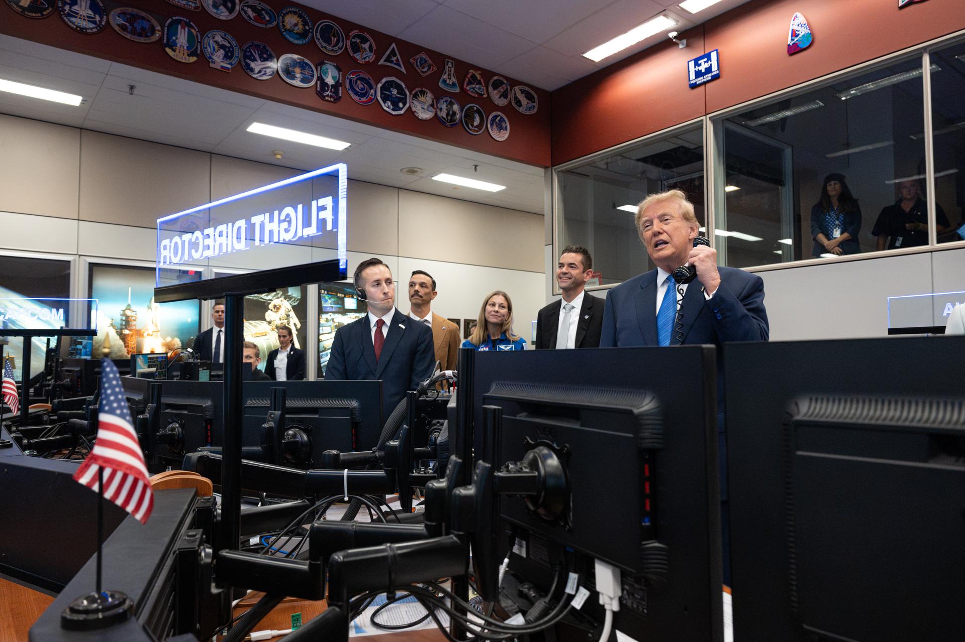 President Donald Trump speaks with Expedition 75 crewmembers Jack Hathaway, Anil Menon, and Jessica Meir on board the International Space Station during a visit to the Christopher C. Kraft Jr. Mission Control Center as NASA Administrator Jared Isaacman and Expedition 75 spouses Duke Brady and NASA astronaut candidate Anna Menon listen, Friday, Aug. 28, 2026, at NASA’s Johnson Space Center in Houston, Texas. Photo Credit: (NASA/John Kraus)