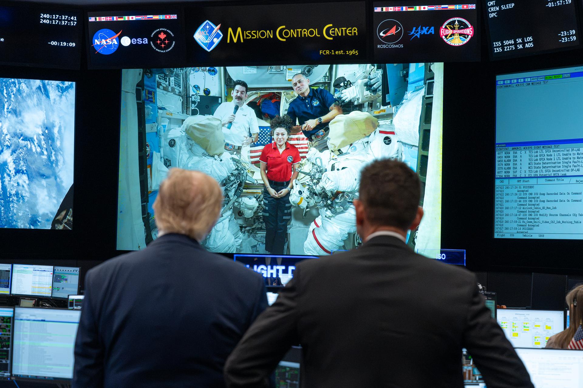 President Donald Trump and NASA Administrator Jared Isaacman listen to Expedition 75 crewmembers Jack Hathaway, Anil Menon, and Jessica Meir on board the International Space Station during a visit to the Christopher C. Kraft Jr. Mission Control Center as NASA Administrator Jared Isaacman and Expedition 75 spouses Duke Brady and NASA astronaut candidate Anna Menon listen, Friday, Aug. 28, 2026, at NASA’s Johnson Space Center in Houston, Texas. Photo Credit: (NASA/John Kraus)