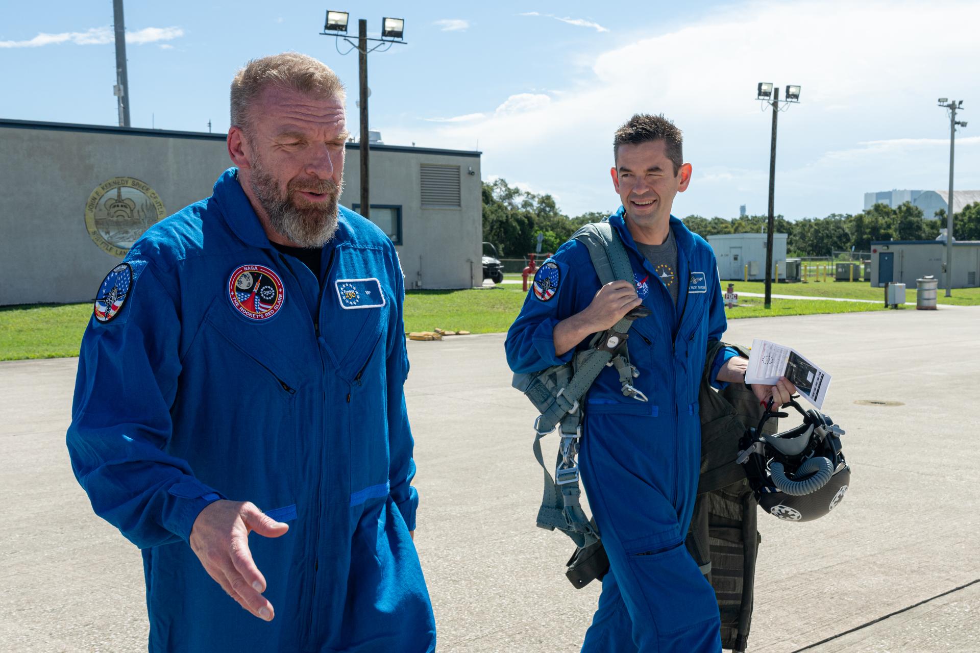 Paul "Triple H" Levesque, left, speaks with NASA Administrator Jared Isaacman, right, ahead of a flight in one of Isaacman's personal Alpha Jet aircraft, Saturday, Aug. 29, 2026, at NASA's Kennedy Space Center in Florida. Photo Credit: (NASA/John Kraus)