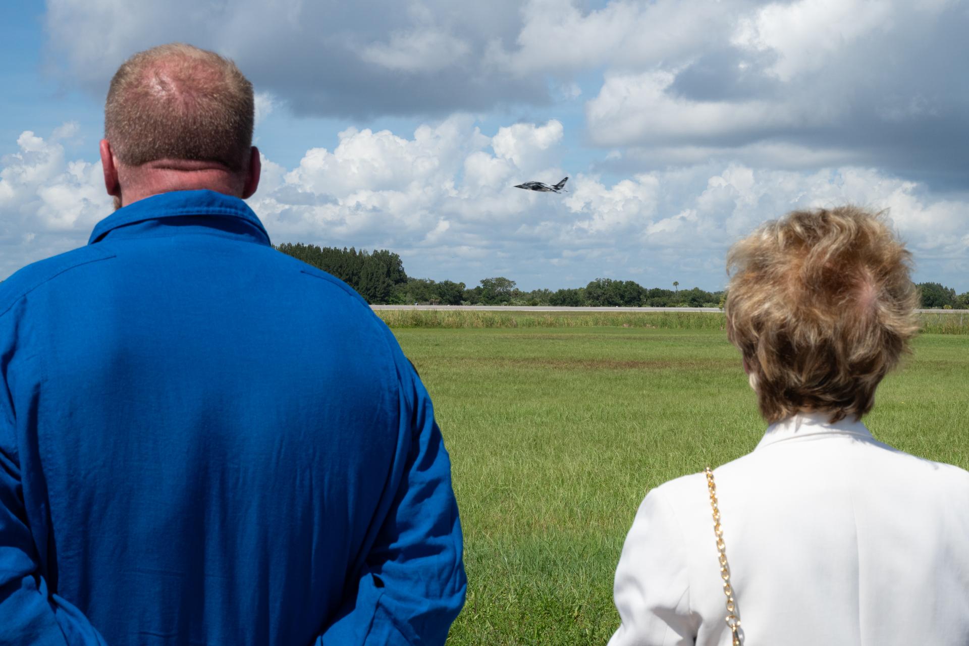 Paul “Triple H” Levesque, left, and Secretary of Education Linda McMahon, right, watch a flyby of NASA Administrator Jared Isaacman’s personal Alpha Jet, with Stephanie McMahon, Levesque’s wife and McMahon’s daughter, flying in the back seat, Saturday, Aug. 29, 2026, at NASA’s Kennedy Space Center in Florida. Photo Credit: (NASA/John Kraus)
