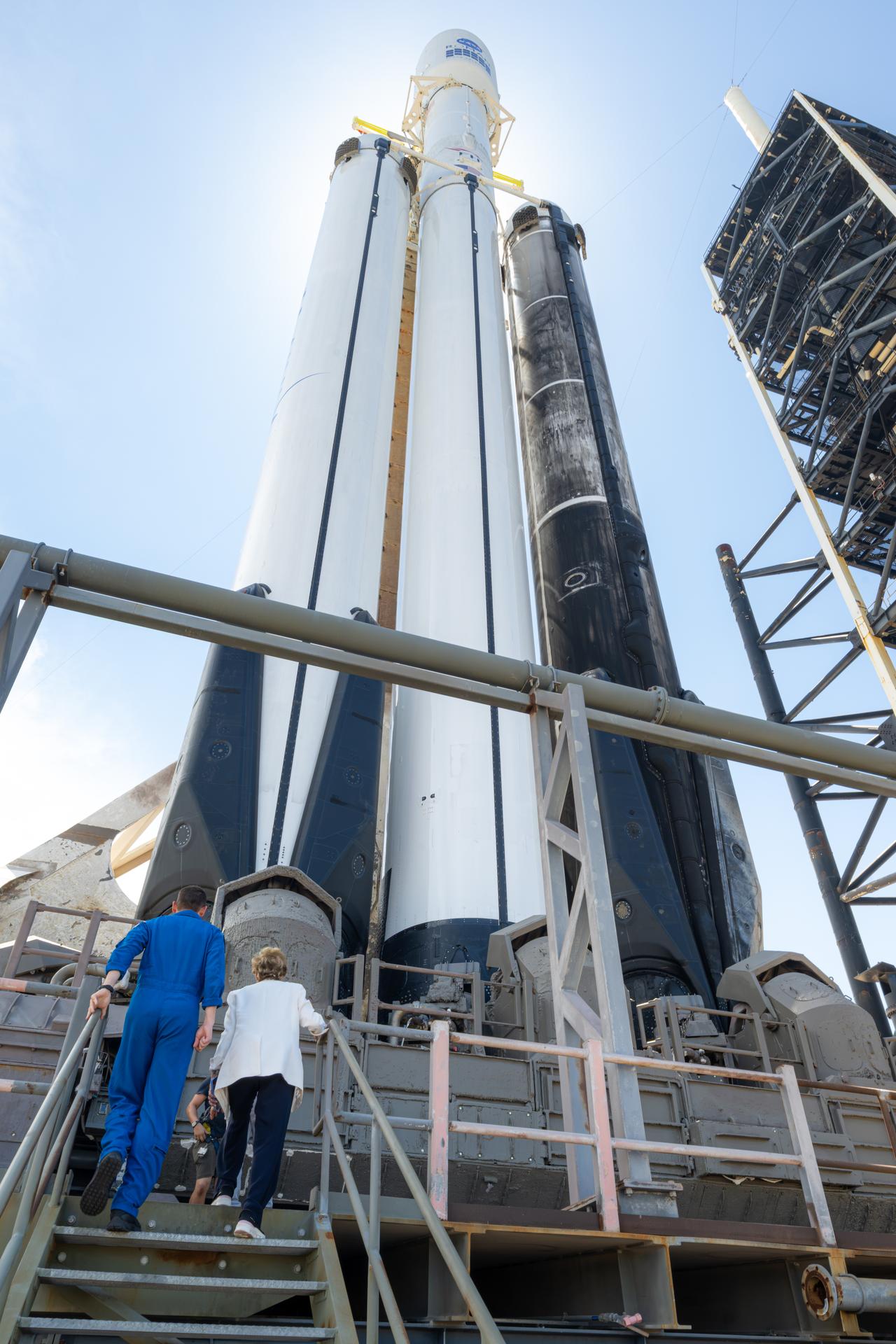 NASA Administrator Jared Isaacman, left, and Sectretary of Education Linda McMahon, right, are seen with the SpaceX Falcon Heavy rocket poised to launch NASA’s Nancy Grace Roman Space Telescope, Saturday, Aug. 29, 2026, at Launch Complex 39A at NASA's Kennedy Space Center in Florida. Photo Credit: (NASA/John Kraus)