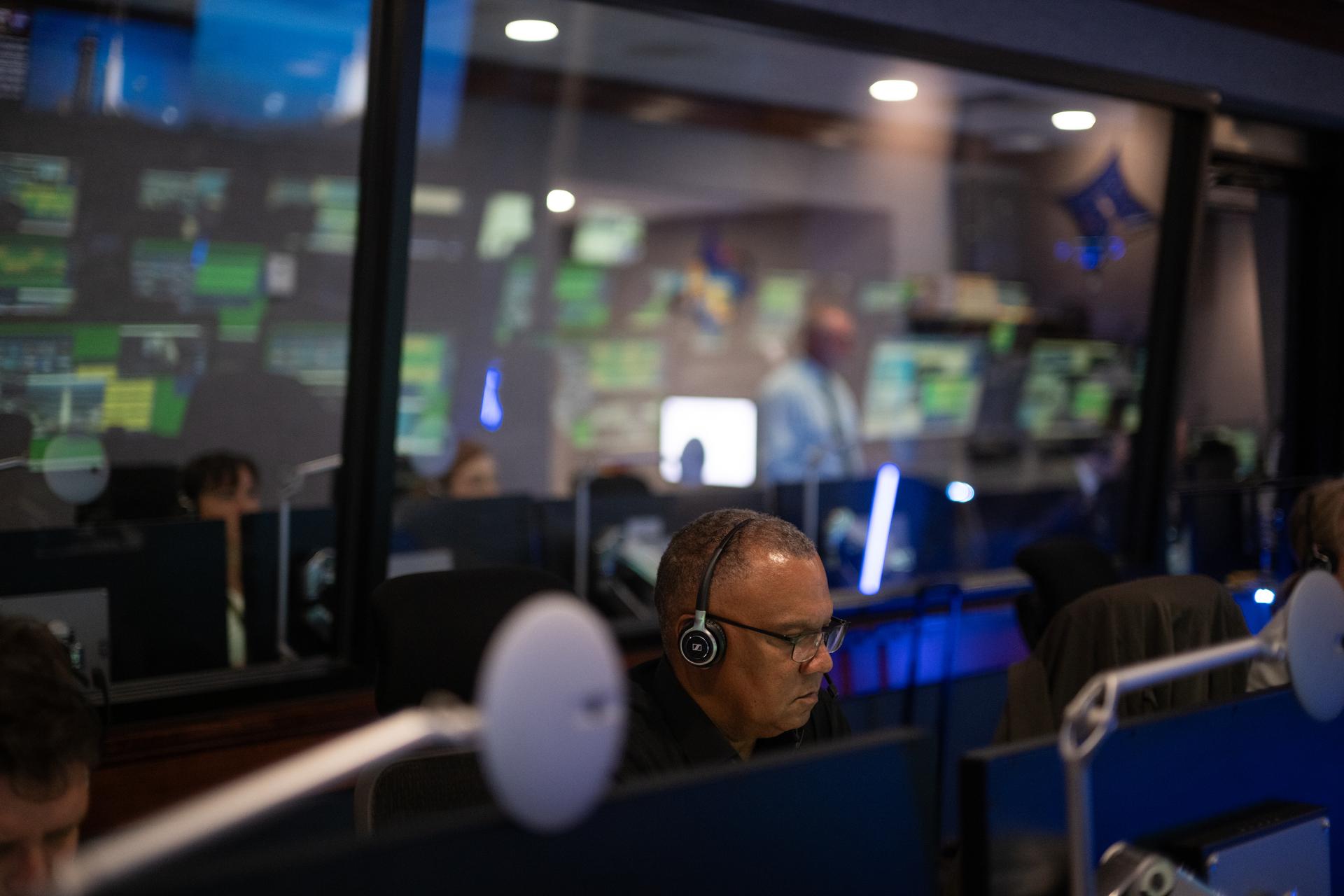 Brian Smith, chief of the program business office for NASA’s Launch Services Program, monitors the countdown inside Hangar AE at Cape Canaveral Space Force Station for the launch of a SpaceX Falcon Heavy rocket with NASA’S Nancy Grace Roman Space Telescope from Launch Complex 39A at NASA’s Kennedy Space Center, Sunday, Aug. 30, 2026, in Florida. Roman will investigate dark energy and dark matter, conduct a statistical census of planetary systems, and enable a broad range of additional astrophysics research. Launch occurred at 7:26 a.m. EDT. Photo Credit (NASA/Joel Kowsky)