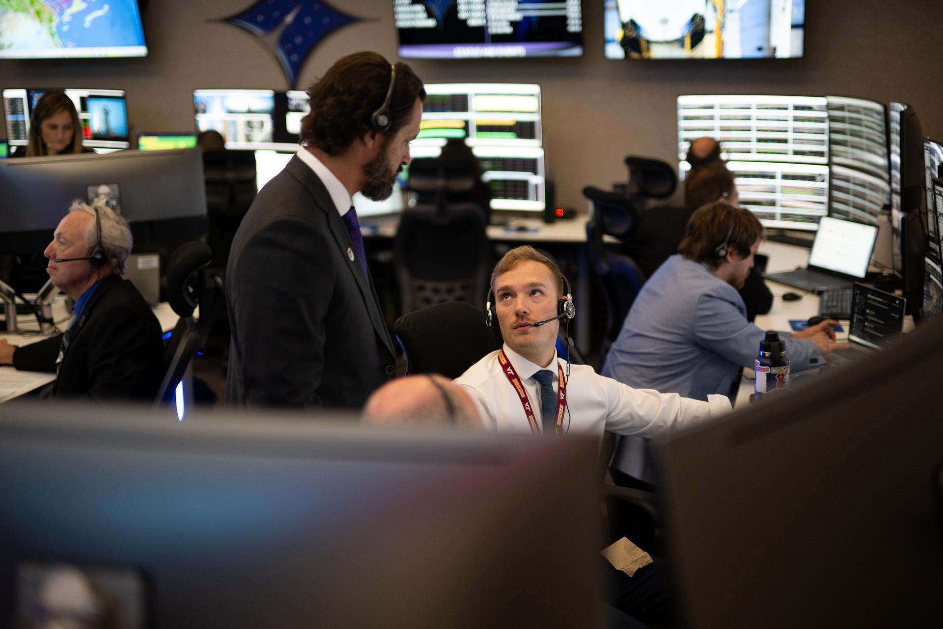 Aaron Smith, senior vehicle systems engineer for NASA’s Launch Services Program, left, talks with Daniel Safewright, a ground systems engineer at NASA’s Kennedy Space Center, as they monitor the countdown inside Hangar AE at Cape Canaveral Space Force Station for the launch of a SpaceX Falcon Heavy rocket with NASA’S Nancy Grace Roman Space Telescope from Launch Complex 39A at NASA’s Kennedy Space Center, Sunday, Aug. 30, 2026, in Florida. Roman will investigate dark energy and dark matter, conduct a statistical census of planetary systems, and enable a broad range of additional astrophysics research. Launch occurred at 7:26 a.m. EDT. Photo Credit (NASA/Joel Kowsky)