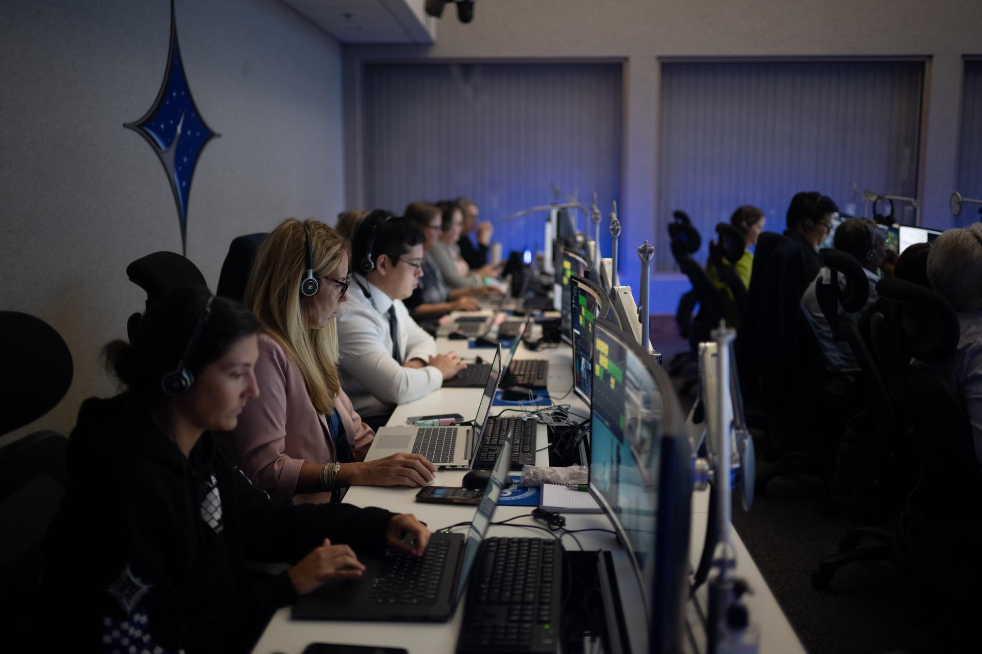 Kris Nighswonger, of NASA’s Launch Services Program, second from left,monitors the countdown inside Hangar AE at Cape Canaveral Space Force Station for the launch of a SpaceX Falcon Heavy rocket with NASA’S Nancy Grace Roman Space Telescope from Launch Complex 39A at NASA’s Kennedy Space Center, Sunday, Aug. 30, 2026, in Florida. Roman will investigate dark energy and dark matter, conduct a statistical census of planetary systems, and enable a broad range of additional astrophysics research. Launch occurred at 7:26 a.m. EDT. Photo Credit (NASA/Joel Kowsky)