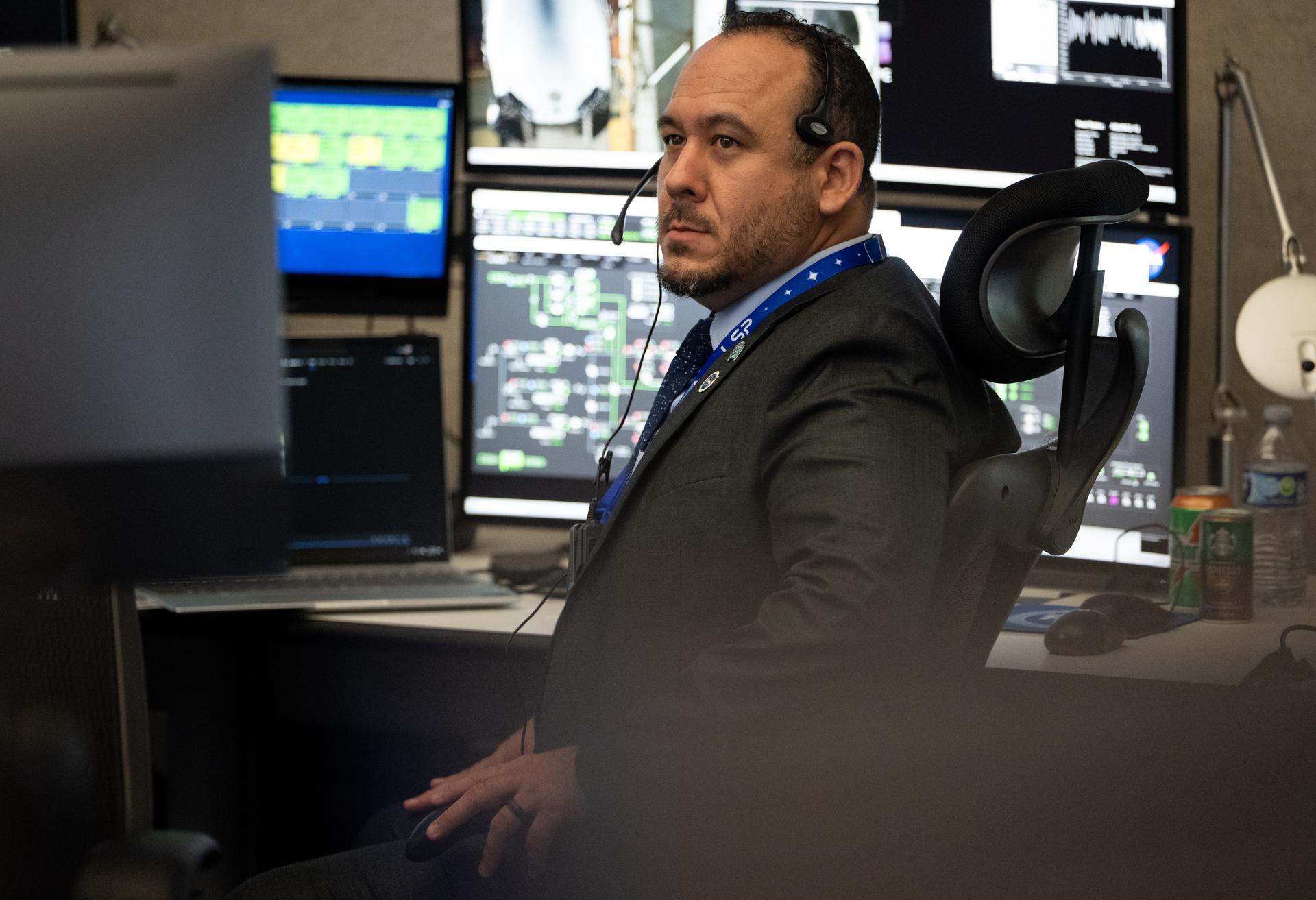 Stephen Way, a mission integration engineer for NASA’s Launch Services Program, monitors the countdown inside Hangar AE at Cape Canaveral Space Force Station for the launch of a SpaceX Falcon Heavy rocket with NASA’S Nancy Grace Roman Space Telescope from Launch Complex 39A at NASA’s Kennedy Space Center, Sunday, Aug. 30, 2026, in Florida. Roman will investigate dark energy and dark matter, conduct a statistical census of planetary systems, and enable a broad range of additional astrophysics research. Launch occurred at 7:26 a.m. EDT. Photo Credit (NASA/Joel Kowsky)