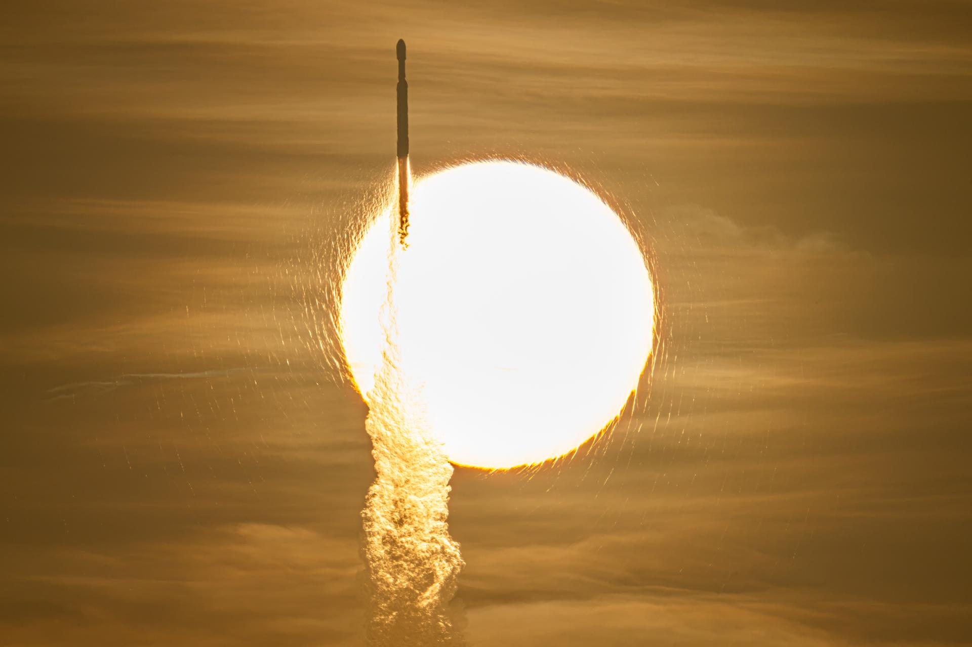 A rocket soars in front of the Sun during liftoff of NASA's Nancy Grace Roman Space Telescope on Sunday, Aug. 30, 2026.