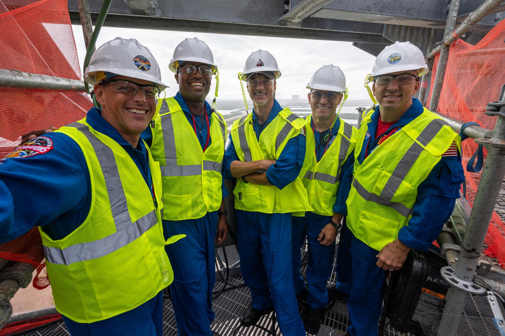 Artemis III crewmembers NASA astronauts Bob Hines, backup crewmember; Andre Douglas, mission specialist; European Space Agency astronaut Luca Parmitano, pilot; and NASA astronauts Frank Rubio, mission specialist; and Randy Bresnik, commander, pose for a photograph at the top of the Starship launch tower at Launch Complex 39A, Thursday, Sept. 3, 2026, at NASA’s Kennedy Space Center in Florida. Photo Credit: (NASA/John Kraus)