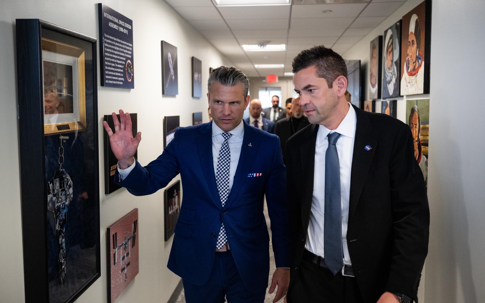 Secretary of War Pete Hegseth, left, and NASA Administrator Jared Isaacman are seen as they arrive at a meeting of the Presidential Commission on the United States Space Academy in the Space Operations Center, Wednesday, Sept. 9, 2026, at the Mary W. Jackson NASA Headquarters Building in Washington. The commission will meet and submit a report proposing recommendations for the establishment of the Space Academy. Photo Credit (NASA/Joel Kowsky)