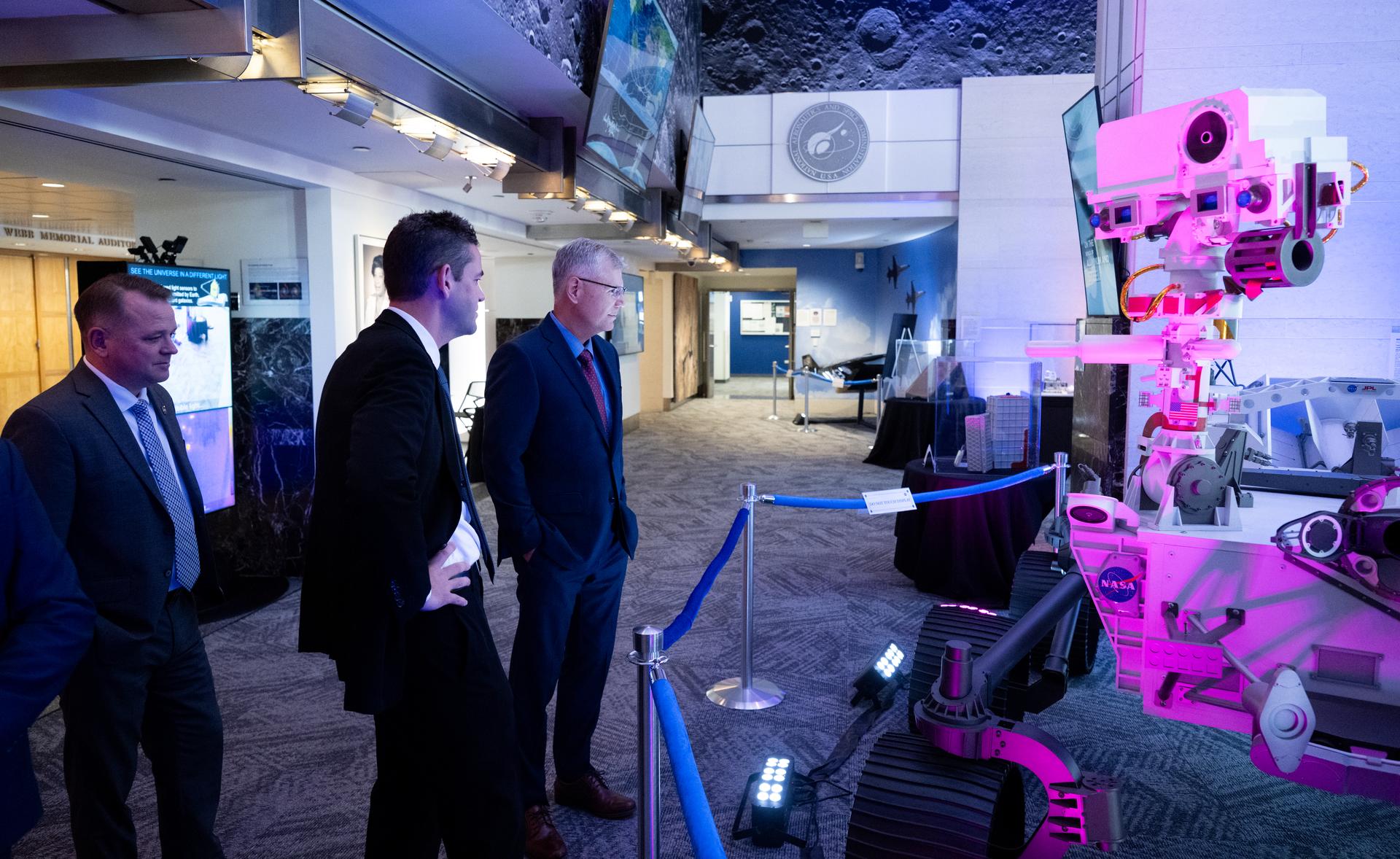 Troy Meink, Secretary of the United States Air Force, right, looks at a model of NASA’s Perseverance rover NASA Administrator Jared Isaacman, center, and NASA Deputy Administrator Matt Anderson, left, after arriving for a meeting of the Presidential Commission on the United States Space Academy at the Mary W. Jackson NASA Headquarters Building, Wednesday, Sept. 9, 2026, in Washington.  The commission will meet and submit a report proposing recommendations for the establishment of the Space Academy.  Photo Credit (NASA/Joel Kowsky)