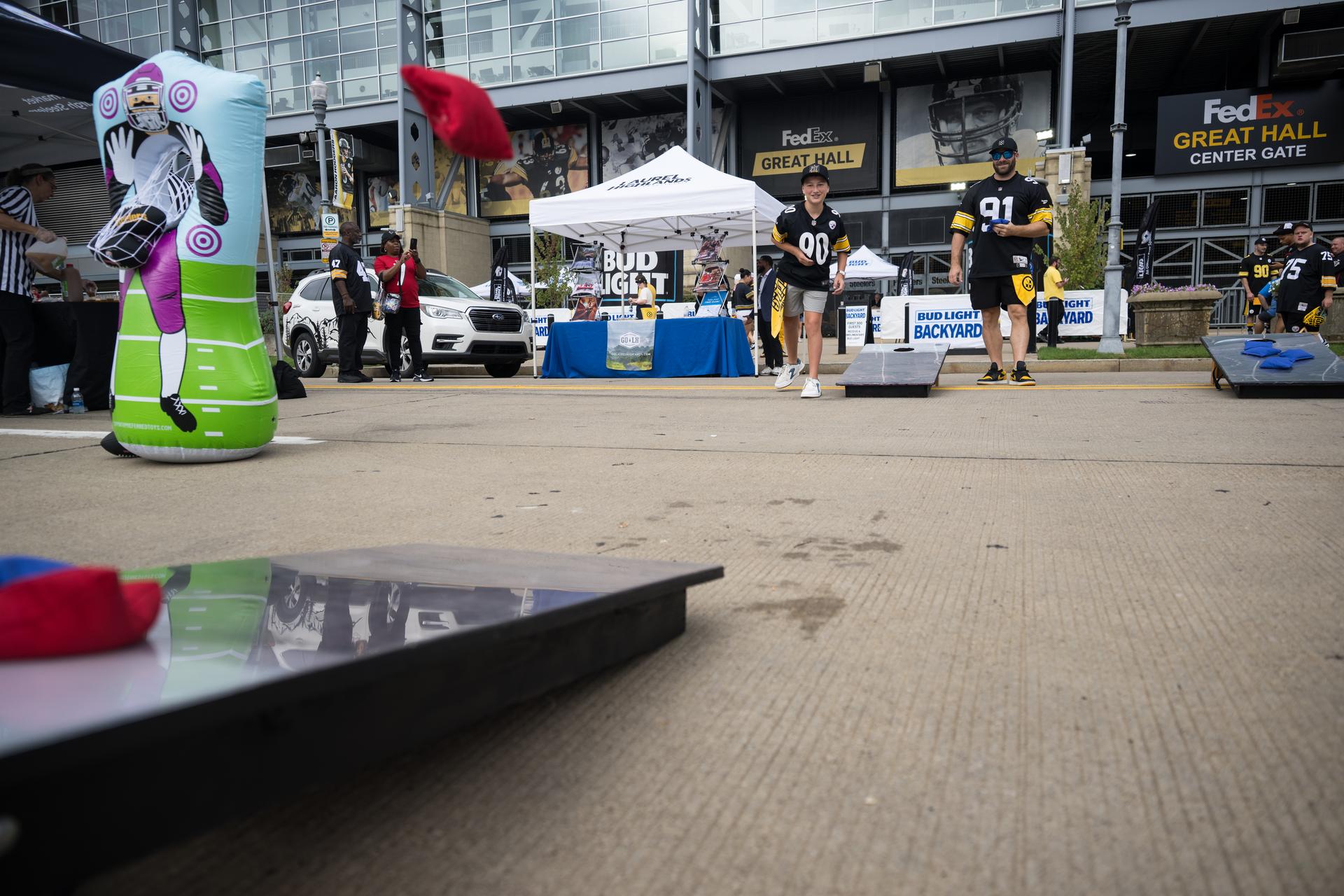 Fans play corn hole in the NASA Experience Zone at an NFL game between the Pittsburgh Steelers and the Atlanta Falcons at Acrisure Stadium, Sunday, Sept. 13, 2026, in Pittsburgh, Pennsylvania. NASA’s engagement at NFL games is part of the agency's Inspiration Tour, aimed at strengthening connections between NASA and its partners and showcasing innovation in air and space in the lead up to the MAX POWER aerospace technology expo and airshow at the agency's Kennedy Space Center in early November. Photo Credit: (NASA/Aubrey Gemignani)