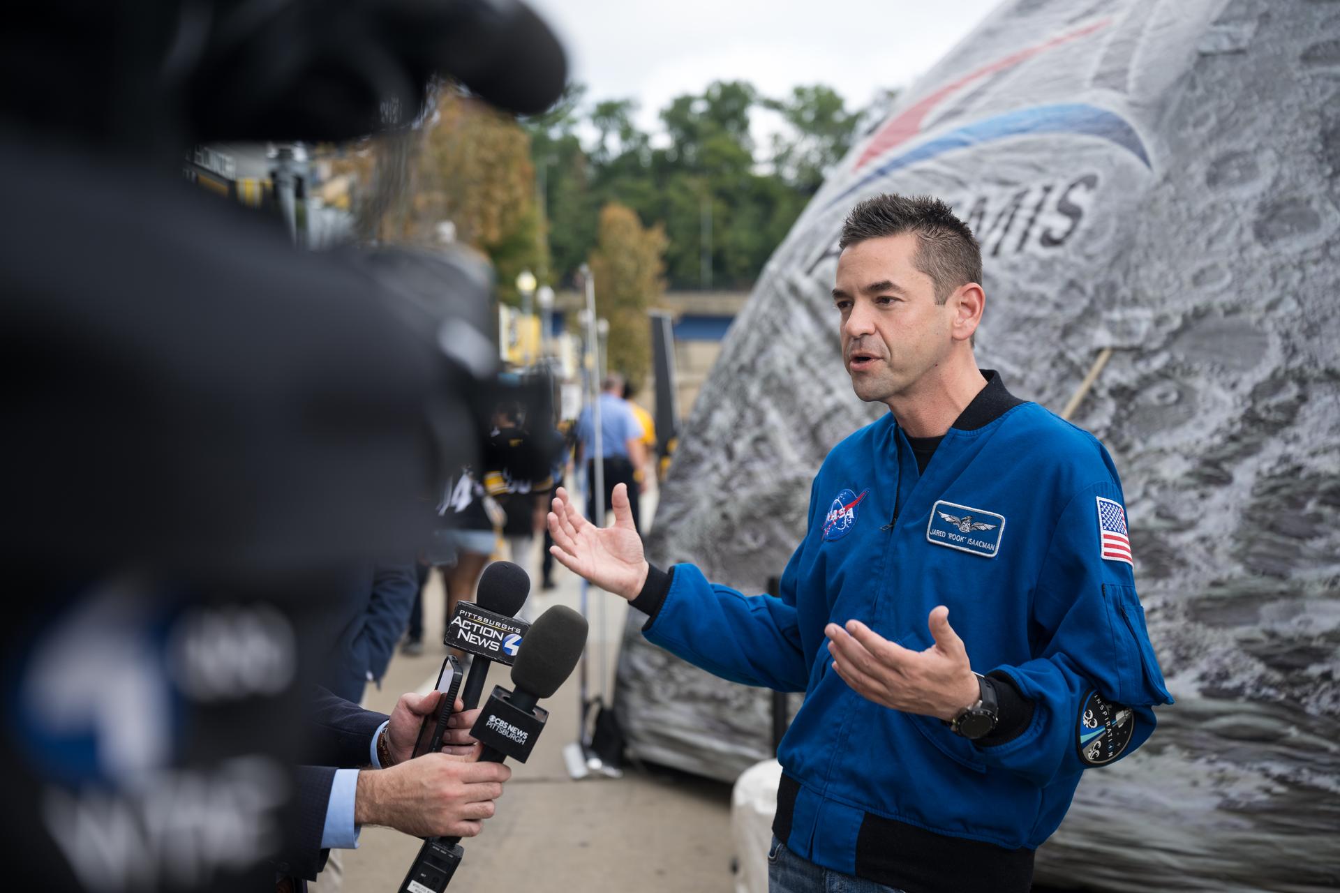 NASA Administrator Jared Isaacman is interviewed by media outside the NASA Experience Zone at an NFL game between the Pittsburgh Steelers and the Atlanta Falcons at Acrisure Stadium, Sunday, Sept. 13, 2026, in Pittsburgh, Pennsylvania. NASA’s engagement at NFL games is part of the agency's Inspiration Tour, aimed at strengthening connections between NASA and its partners and showcasing innovation in air and space in the lead up to the MAX POWER aerospace technology expo and airshow at the agency's Kennedy Space Center in early November. Photo Credit: (NASA/Aubrey Gemignani)
