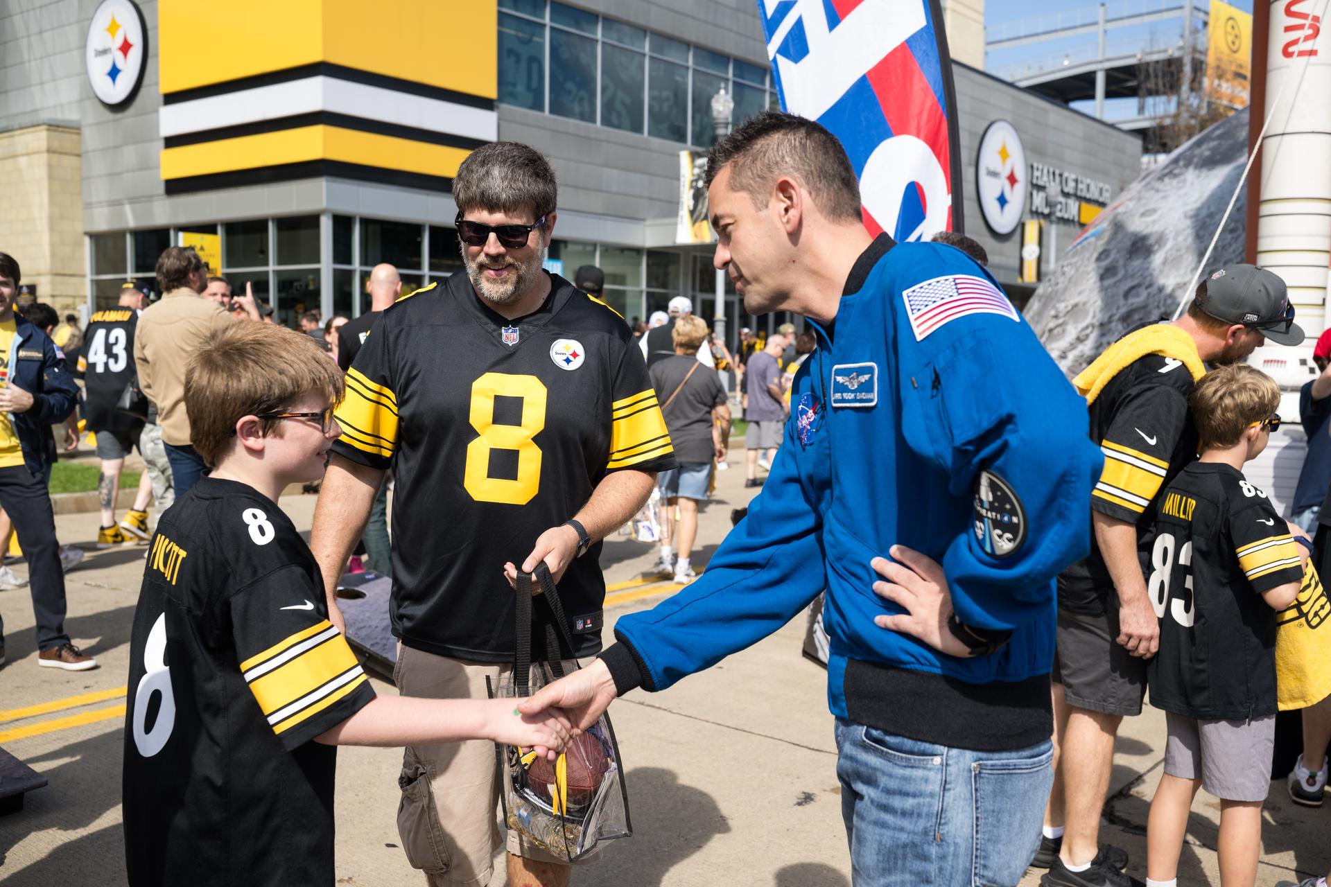 NASA Administrator Jared Isaacman greets fans outside the NASA Experience Zone at an NFL game between the Pittsburgh Steelers and the Atlanta Falcons at Acrisure Stadium, Sunday, Sept. 13, 2026, in Pittsburgh, Pennsylvania. NASA’s engagement at NFL games is part of the agency's Inspiration Tour, aimed at strengthening connections between NASA and its partners and showcasing innovation in air and space in the lead up to the MAX POWER aerospace technology expo and airshow at the agency's Kennedy Space Center in early November. Photo Credit: (NASA/Aubrey Gemignani)