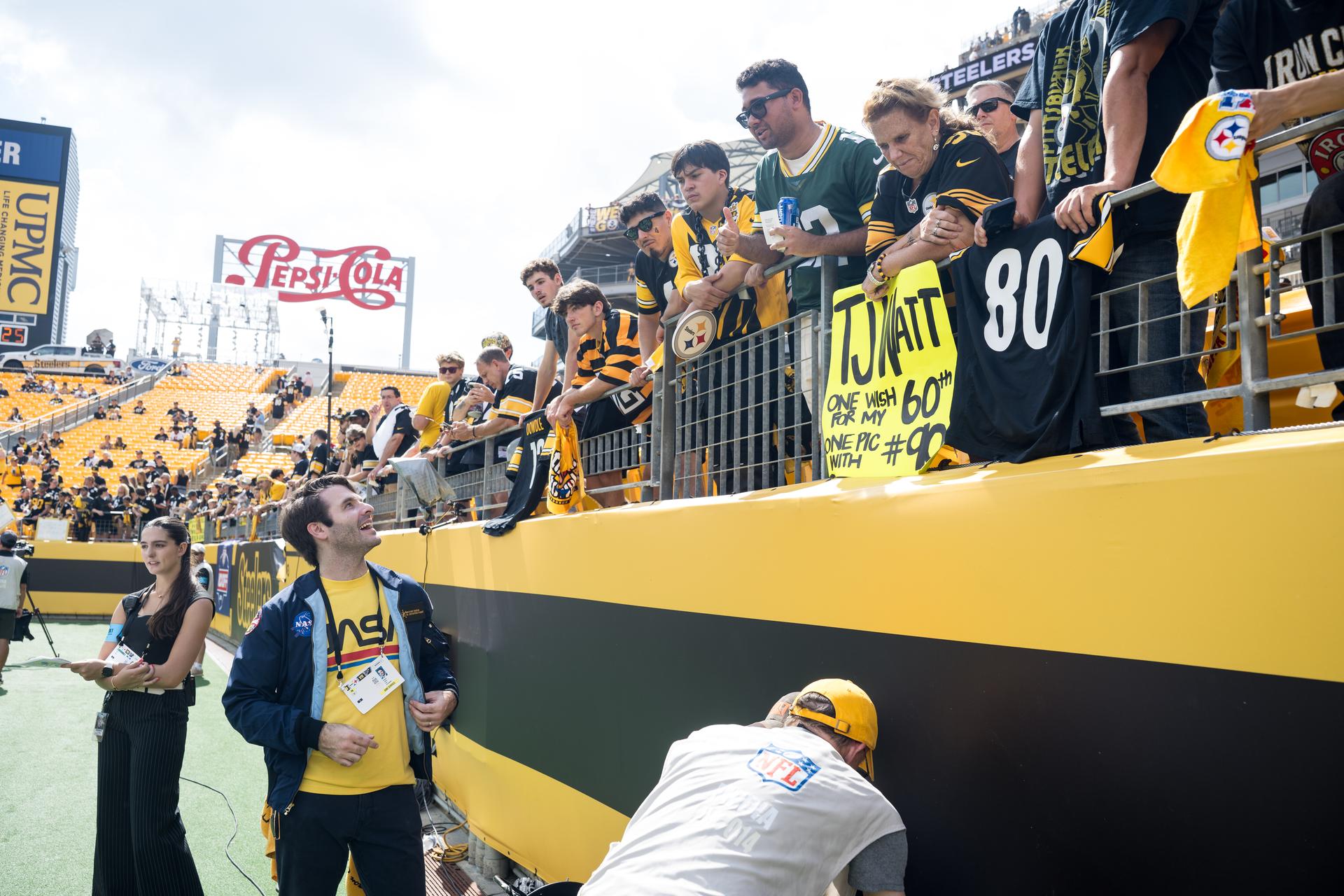 Anthony Vareha, NASA Flight Director, greets fans at an NFL game between the Pittsburgh Steelers and the Atlanta Falcons at Acrisure Stadium, Sunday, Sept. 13, 2026, in Pittsburgh, Pennsylvania. NASA’s engagement at NFL games is part of the agency's Inspiration Tour, aimed at strengthening connections between NASA and its partners and showcasing innovation in air and space in the lead up to the MAX POWER aerospace technology expo and airshow at the agency's Kennedy Space Center in early November. Photo Credit: (NASA/Aubrey Gemignani)