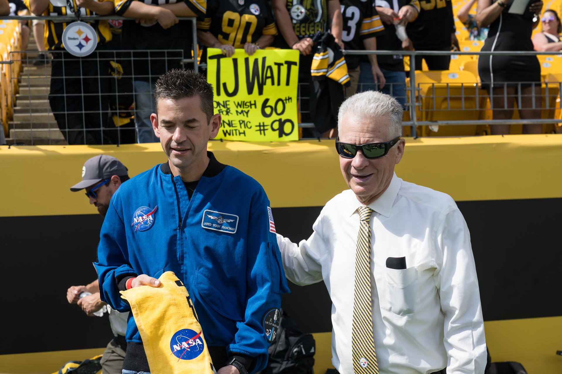 NASA Administrator Jared Isaacman receives a NASA branded “Terrible Towel” from Art Rooney II, owner of the Pittsburgh Steelers at an NFL game between the Steelers and the Atlanta Falcons at Acrisure Stadium, Sunday, Sept. 13, 2026, in Pittsburgh, Pennsylvania. NASA’s engagement at NFL games is part of the agency's Inspiration Tour, aimed at strengthening connections between NASA and its partners and showcasing innovation in air and space in the lead up to the MAX POWER aerospace technology expo and airshow at the agency's Kennedy Space Center in early November. Photo Credit: (NASA/Aubrey Gemignani)