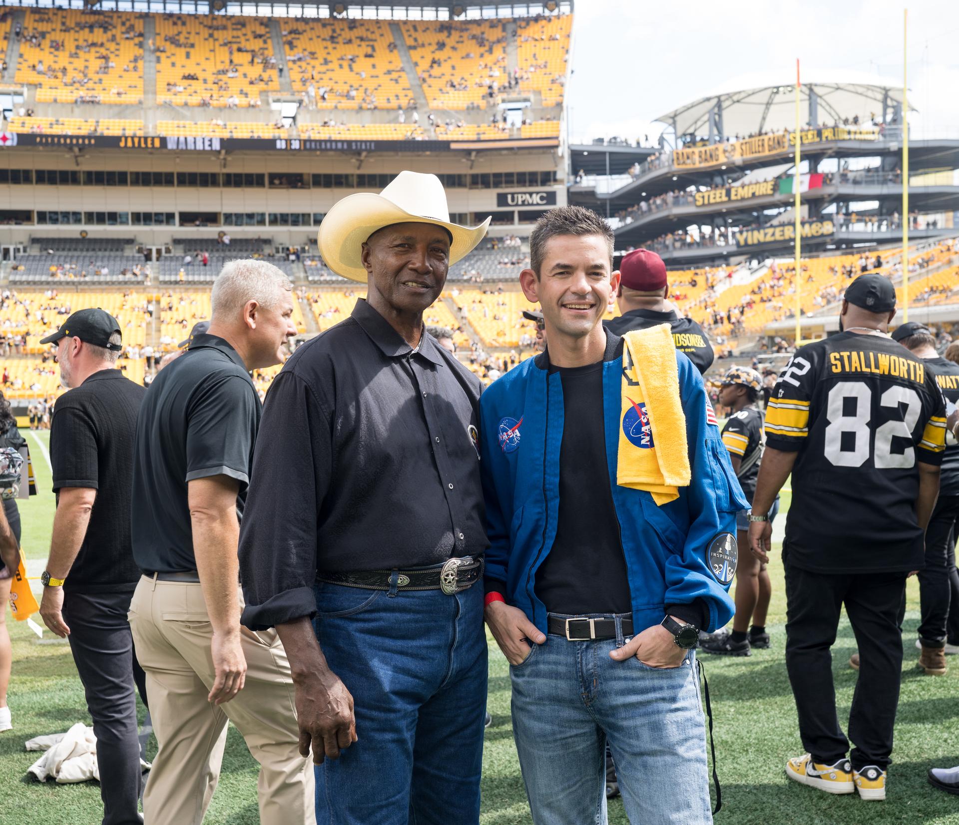 NASA Administrator Jared Isaacman right, poses for a photo with Mel Blount, former Pittsburgh Steelers professional football player at an NFL game between the Pittsburgh Steelers and the Atlanta Falcons at Acrisure Stadium, Sunday, Sept. 13, 2026, in Pittsburgh, Pennsylvania. NASA’s engagement at NFL games is part of the agency's Inspiration Tour, aimed at strengthening connections between NASA and its partners and showcasing innovation in air and space in the lead up to the MAX POWER aerospace technology expo and airshow at the agency's Kennedy Space Center in early November. Photo Credit: (NASA/Aubrey Gemignani)