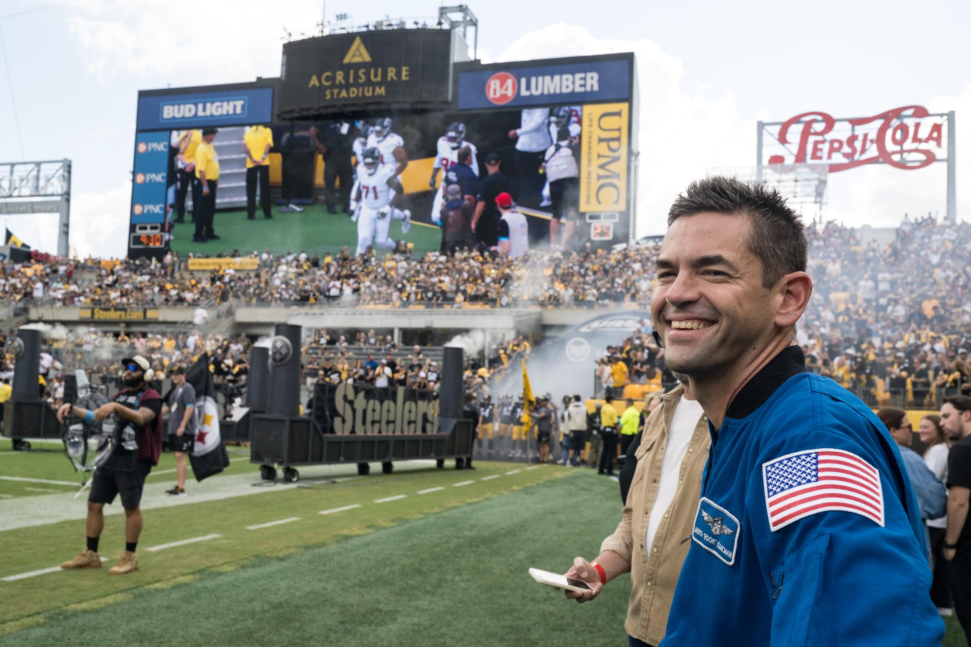NASA Administrator Jared Isaacman watches the entrance of the Atlanta Falcons at an NFL game between the Pittsburgh Steelers and the Atlanta Falcons at Acrisure Stadium, Sunday, Sept. 13, 2026, in Pittsburgh, Pennsylvania. NASA’s engagement at NFL games is part of the agency's Inspiration Tour, aimed at strengthening connections between NASA and its partners and showcasing innovation in air and space in the lead up to the MAX POWER aerospace technology expo and airshow at the agency's Kennedy Space Center in early November. Photo Credit: (NASA/Aubrey Gemignani)