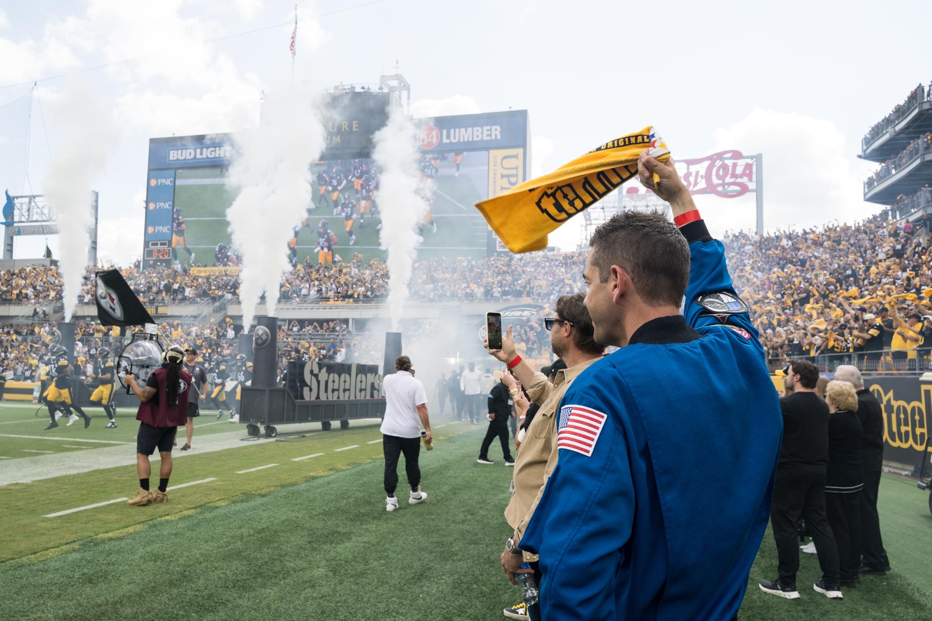 NASA Administrator Jared Isaacman watches the entrance of the Pittsburgh Steelers at an NFL game between the Steelers and the Atlanta Falcons at Acrisure Stadium, Sunday, Sept. 13, 2026, in Pittsburgh, Pennsylvania. NASA’s engagement at NFL games is part of the agency's Inspiration Tour, aimed at strengthening connections between NASA and its partners and showcasing innovation in air and space in the lead up to the MAX POWER aerospace technology expo and airshow at the agency's Kennedy Space Center in early November. Photo Credit: (NASA/Aubrey Gemignani)