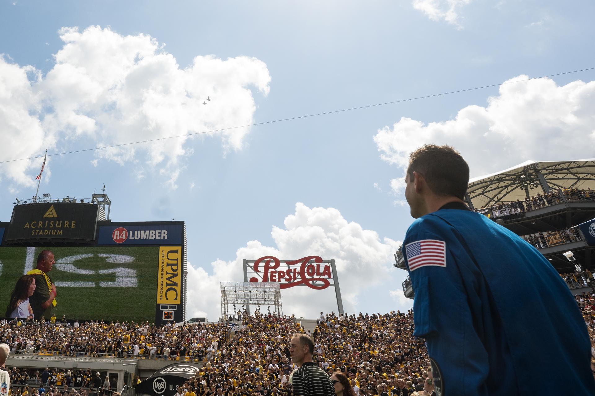 NASA Administrator Jared Isaacman watches as two NASA T-38 Talon aircrafts conduct a flyover at an NFL game between the Pittsburgh Steelers and the Atlanta Falcons at Acrisure Stadium, Sunday, Sept. 13, 2026, in Pittsburgh, Pennsylvania. NASA’s engagement at NFL games is part of the agency's Inspiration Tour, aimed at strengthening connections between NASA and its partners and showcasing innovation in air and space in the lead up to the MAX POWER aerospace technology expo and airshow at the agency's Kennedy Space Center in early November. Photo Credit: (NASA/Aubrey Gemignani)