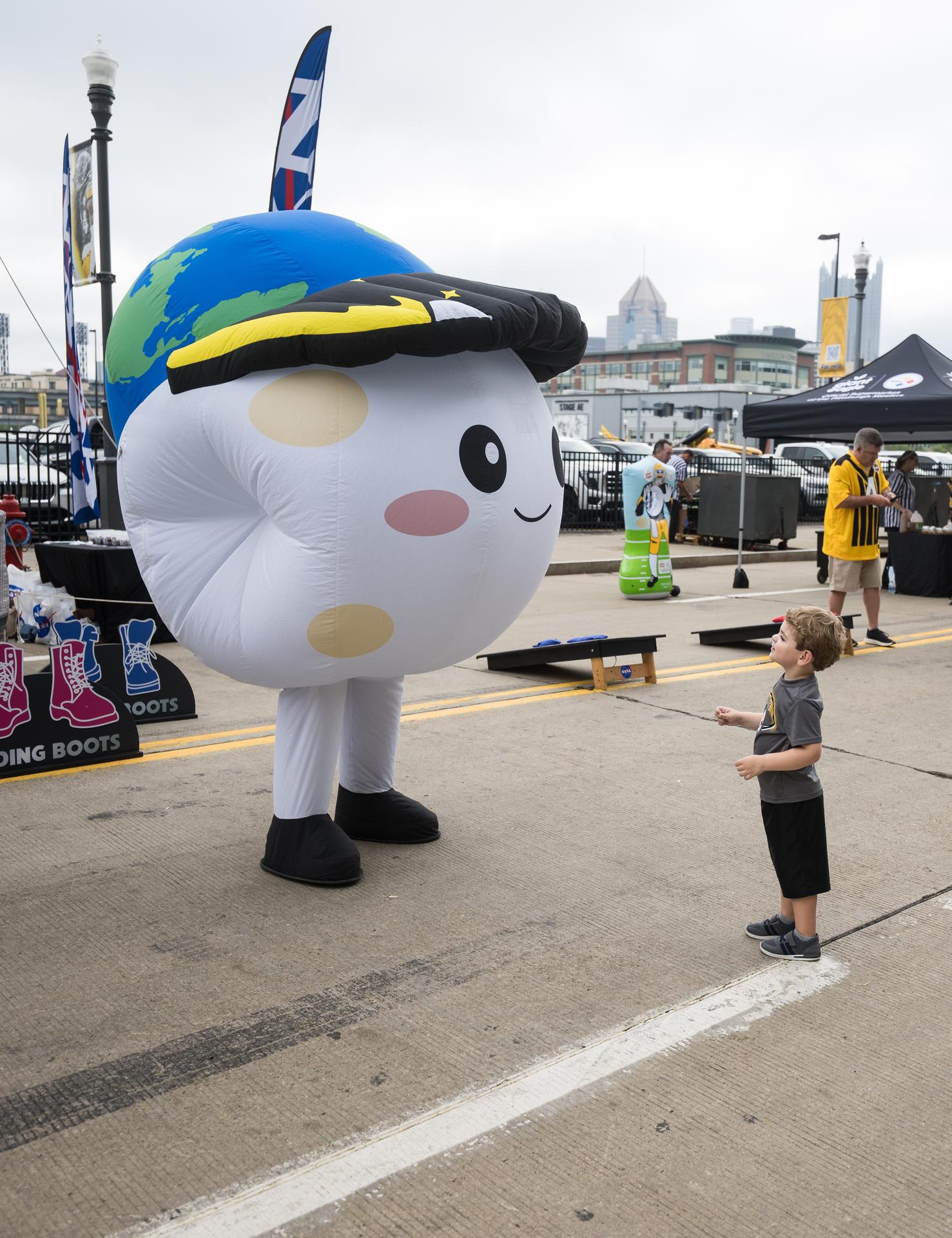 A young fan meets Rise, the zero gravity indicator for the Artemis II mission, in the NASA Experience Zone at an NFL game between the Pittsburgh Steelers and the Atlanta Falcons at Acrisure Stadium, Sunday, Sept. 13, 2026, in Pittsburgh, Pennsylvania. NASA’s engagement at NFL games is part of the agency's Inspiration Tour, aimed at strengthening connections between NASA and its partners and showcasing innovation in air and space in the lead up to the MAX POWER aerospace technology expo and airshow at the agency's Kennedy Space Center in early November. Photo Credit: (NASA/Aubrey Gemignani)