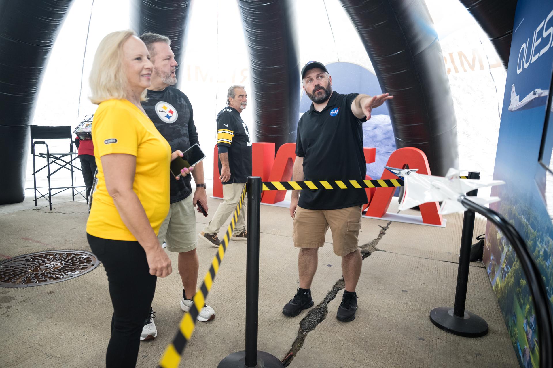 Fans learn about the X-59 supersonic aircraft at the NASA Experience Zone at an NFL game between the Pittsburgh Steelers and the Atlanta Falcons at Acrisure Stadium, Sunday, Sept. 13, 2026, in Pittsburgh, Pennsylvania. NASA’s engagement at NFL games is part of the agency's Inspiration Tour, aimed at strengthening connections between NASA and its partners and showcasing innovation in air and space in the lead up to the MAX POWER aerospace technology expo and airshow at the agency's Kennedy Space Center in early November. Photo Credit: (NASA/Aubrey Gemignani)