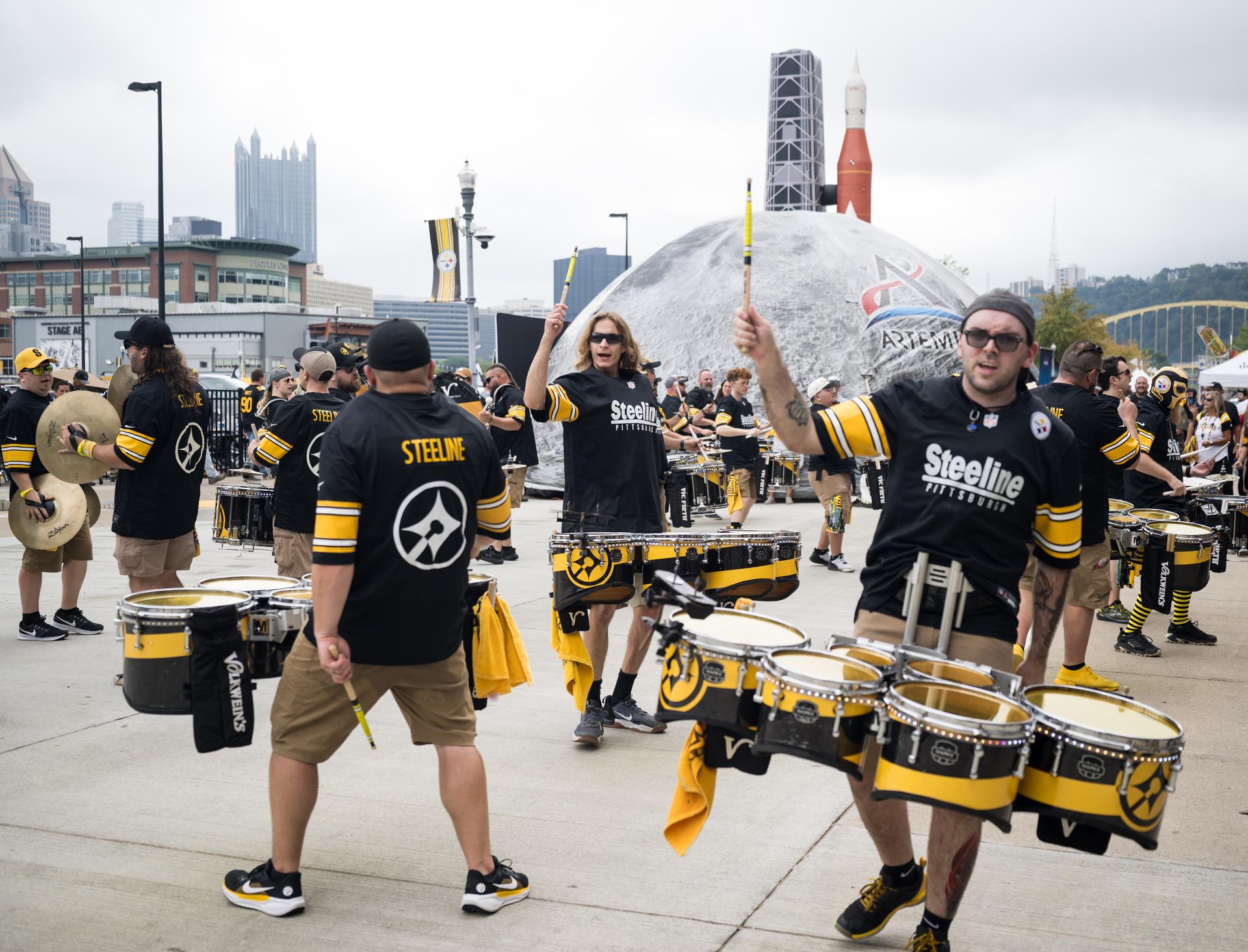 Pittsburgh Steeline, the independent, professional drumline that performs at Pittsburgh Steelers games performs in front of the NASA Experience Zone at an NFL game between the Pittsburgh Steelers and the Atlanta Falcons at Acrisure Stadium, Sunday, Sept. 13, 2026, in Pittsburgh, Pennsylvania. NASA’s engagement at NFL games is part of the agency's Inspiration Tour, aimed at strengthening connections between NASA and its partners and showcasing innovation in air and space in the lead up to the MAX POWER aerospace technology expo and airshow at the agency's Kennedy Space Center in early November. Photo Credit: (NASA/Aubrey Gemignani)
