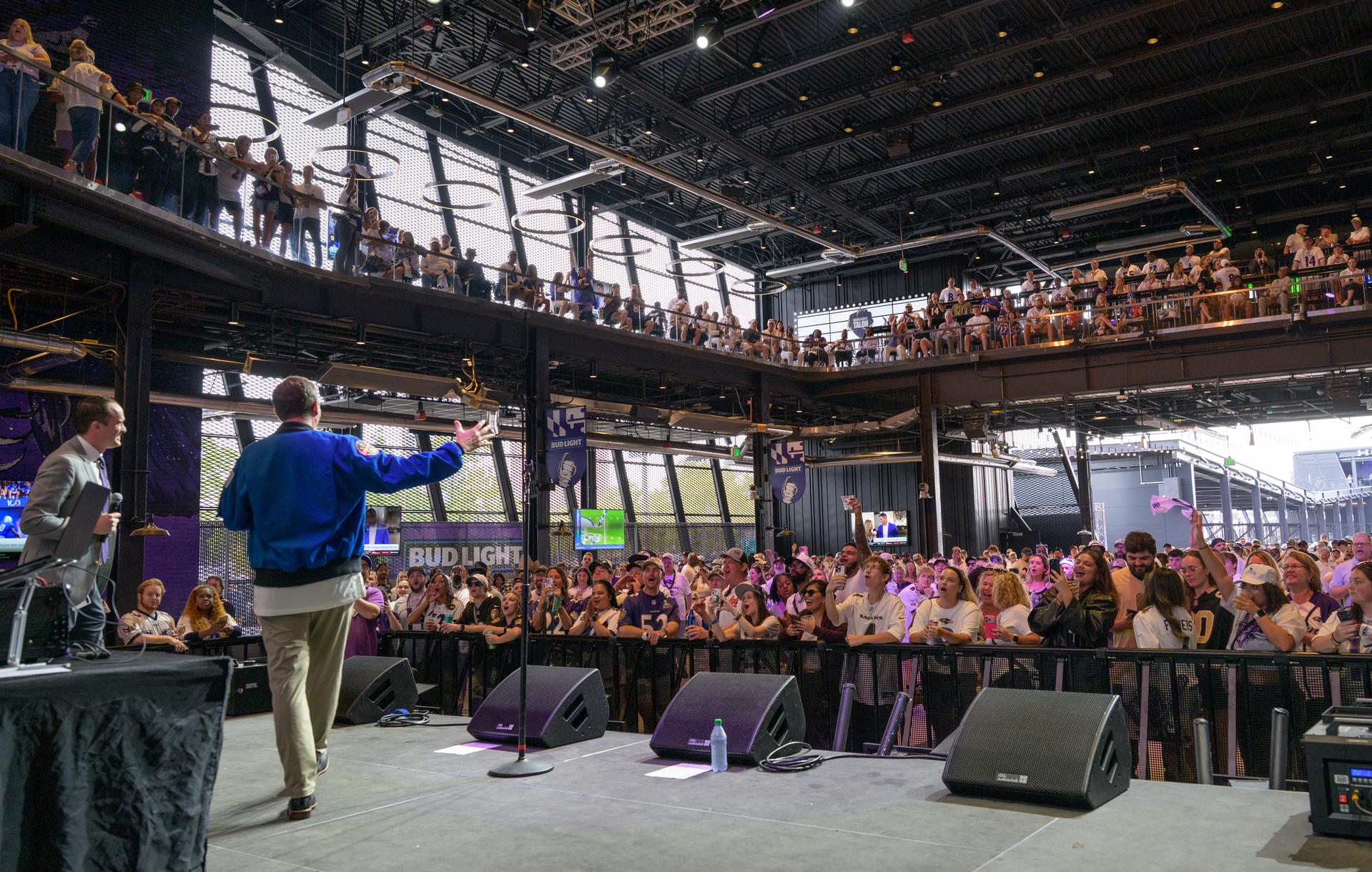 NASA astronaut and commander of the agency’s Artemis II mission, Reid Wiseman, a Baltimore native, joins Garrett Downing, Senior Director of Social Media for the Baltimore Ravens on stage prior to an NFL game between the New Orleans Saints and the Baltimore Ravens at M&T Bank Stadium, Sunday, Sept. 20, 2026, in Baltimore. NASA’s engagement at NFL games is part of the agency's Inspiration Tour, aimed at strengthening connections between NASA and its partners and showcasing innovation in air and space in the lead up to the MAX POWER aerospace technology expo and airshow at the agency's Kennedy Space Center in early November. Photo Credit: (NASA/Bill Ingalls)