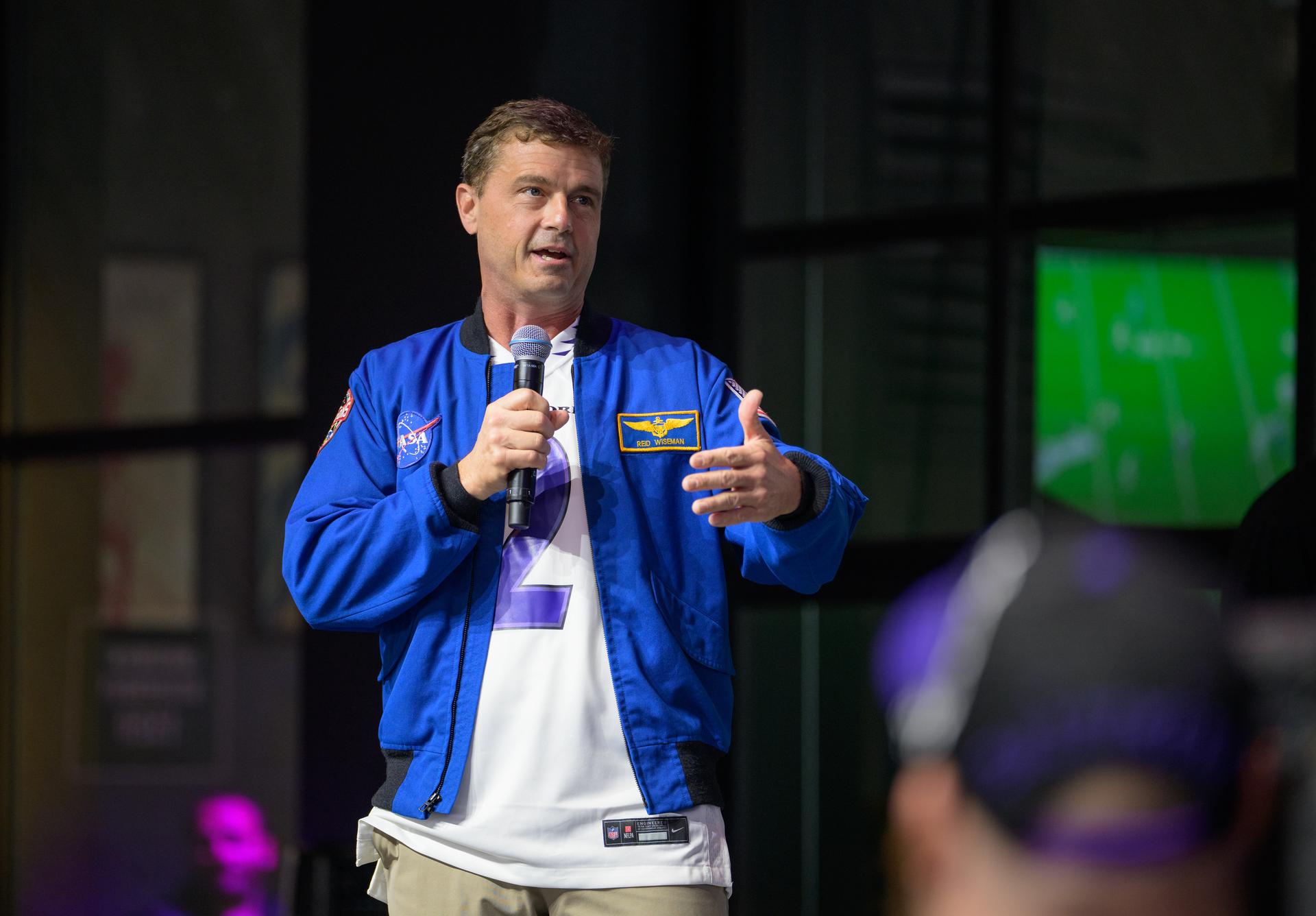 NASA astronaut and commander of the agency’s Artemis II mission, Reid Wiseman, a Baltimore native, talks to fans prior to the start of an NFL game between the New Orleans Saints and the Baltimore Ravens at M&T Bank Stadium, Sunday, Sept. 20, 2026, in Baltimore. NASA’s engagement at NFL games is part of the agency's Inspiration Tour, aimed at strengthening connections between NASA and its partners and showcasing innovation in air and space in the lead up to the MAX POWER aerospace technology expo and airshow at the agency's Kennedy Space Center in early November. Photo Credit: (NASA/Bill Ingalls)