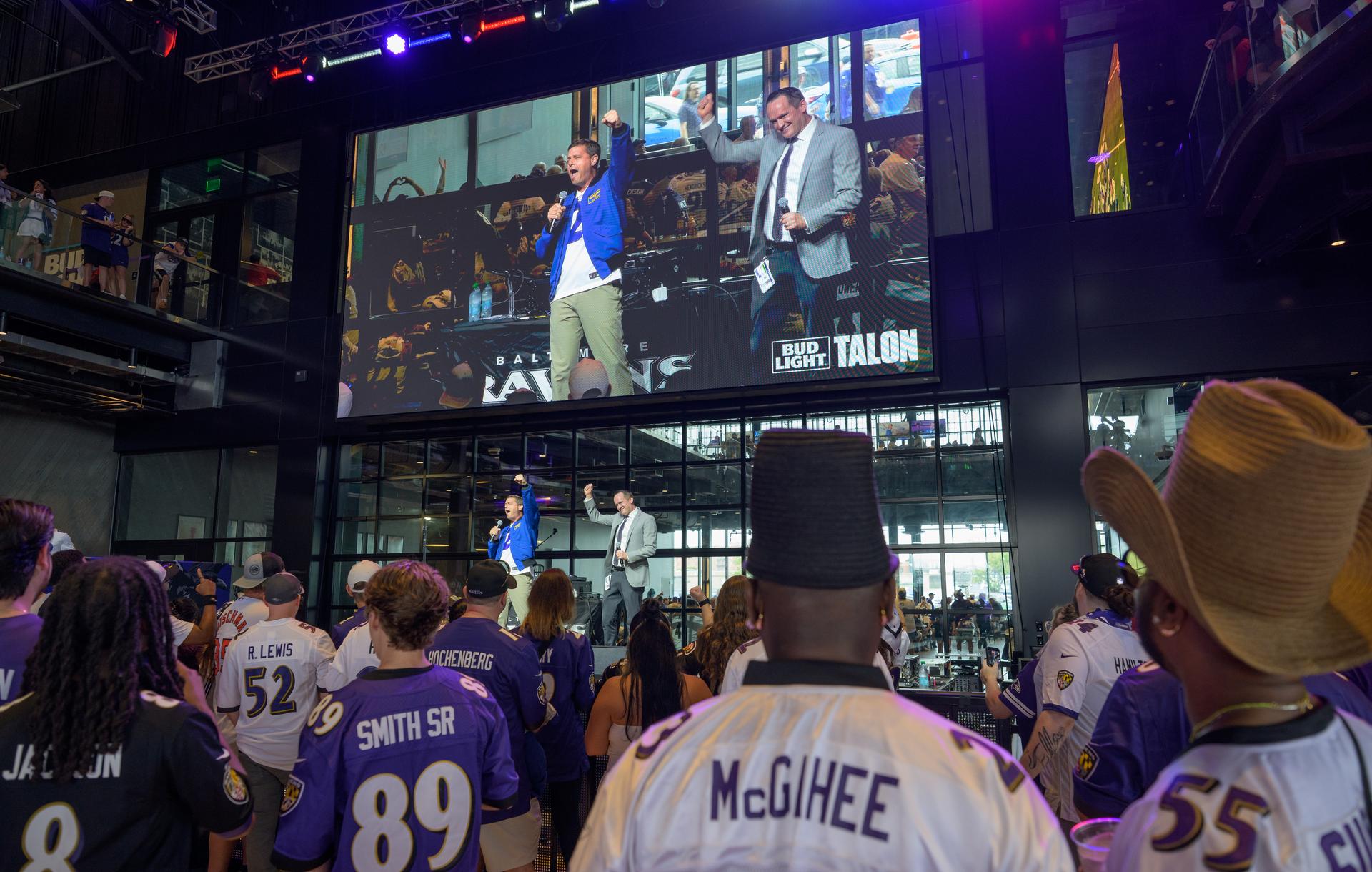 NASA astronaut and commander of the agency’s Artemis II mission, Reid Wiseman, a Baltimore native, joins Garrett Downing, Senior Director of Social Media for the Baltimore Ravens on stage prior to an NFL game between the New Orleans Saints and the Baltimore Ravens at M&T Bank Stadium, Sunday, Sept. 20, 2026, in Baltimore. NASA’s engagement at NFL games is part of the agency's Inspiration Tour, aimed at strengthening connections between NASA and its partners and showcasing innovation in air and space in the lead up to the MAX POWER aerospace technology expo and airshow at the agency's Kennedy Space Center in early November. Photo Credit: (NASA/Bill Ingalls)
