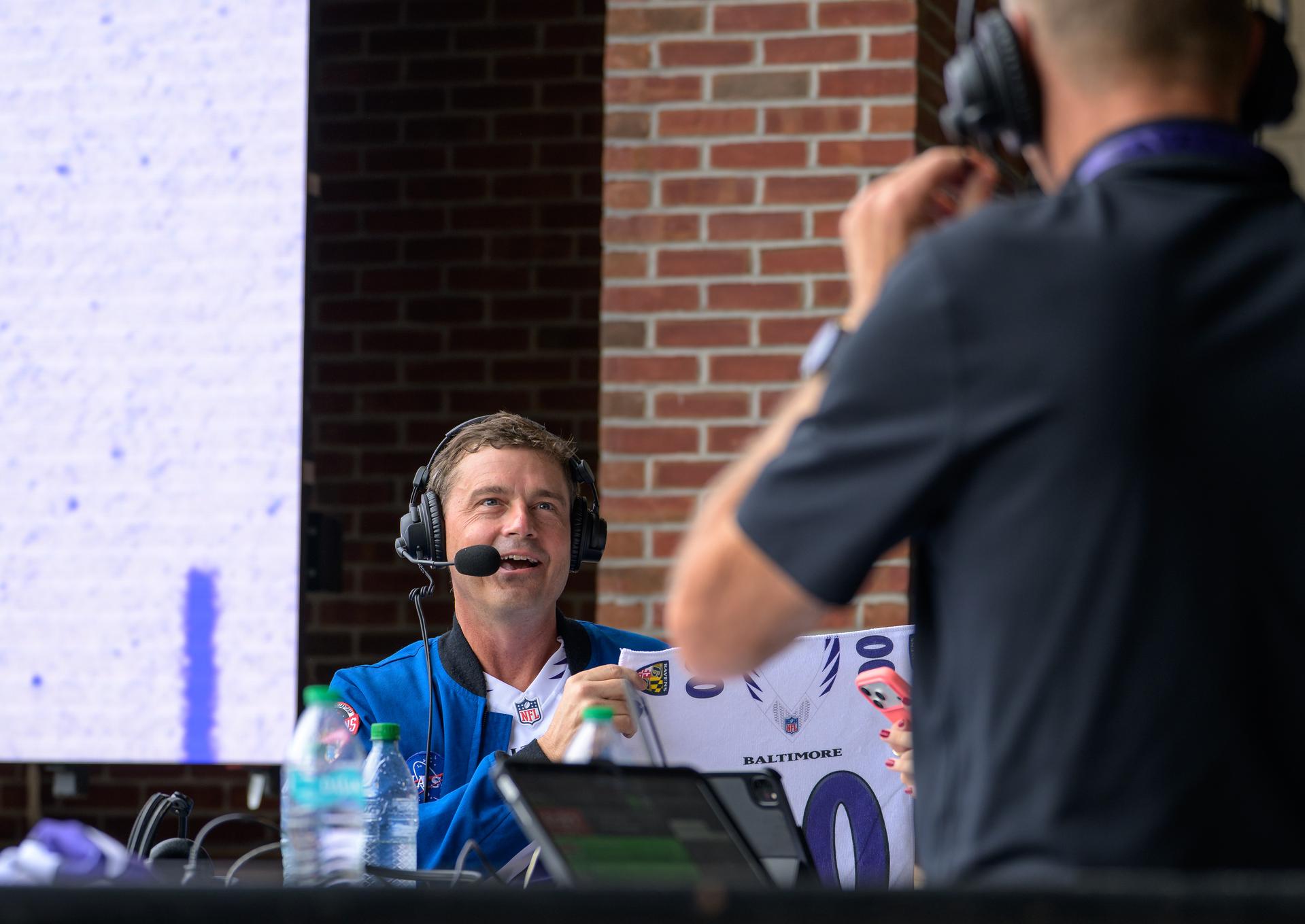 NASA astronaut and commander of the agency’s Artemis II mission, Reid Wiseman, a Baltimore native, is seen during an WBAL radio interview prior to the start of an NFL game between the New Orleans Saints and the Baltimore Ravens at M&T Bank Stadium, Sunday, Sept. 20, 2026, in Baltimore. NASA’s engagement at NFL games is part of the agency's Inspiration Tour, aimed at strengthening connections between NASA and its partners and showcasing innovation in air and space in the lead up to the MAX POWER aerospace technology expo and airshow at the agency's Kennedy Space Center in early November. Photo Credit: (NASA/Bill Ingalls)