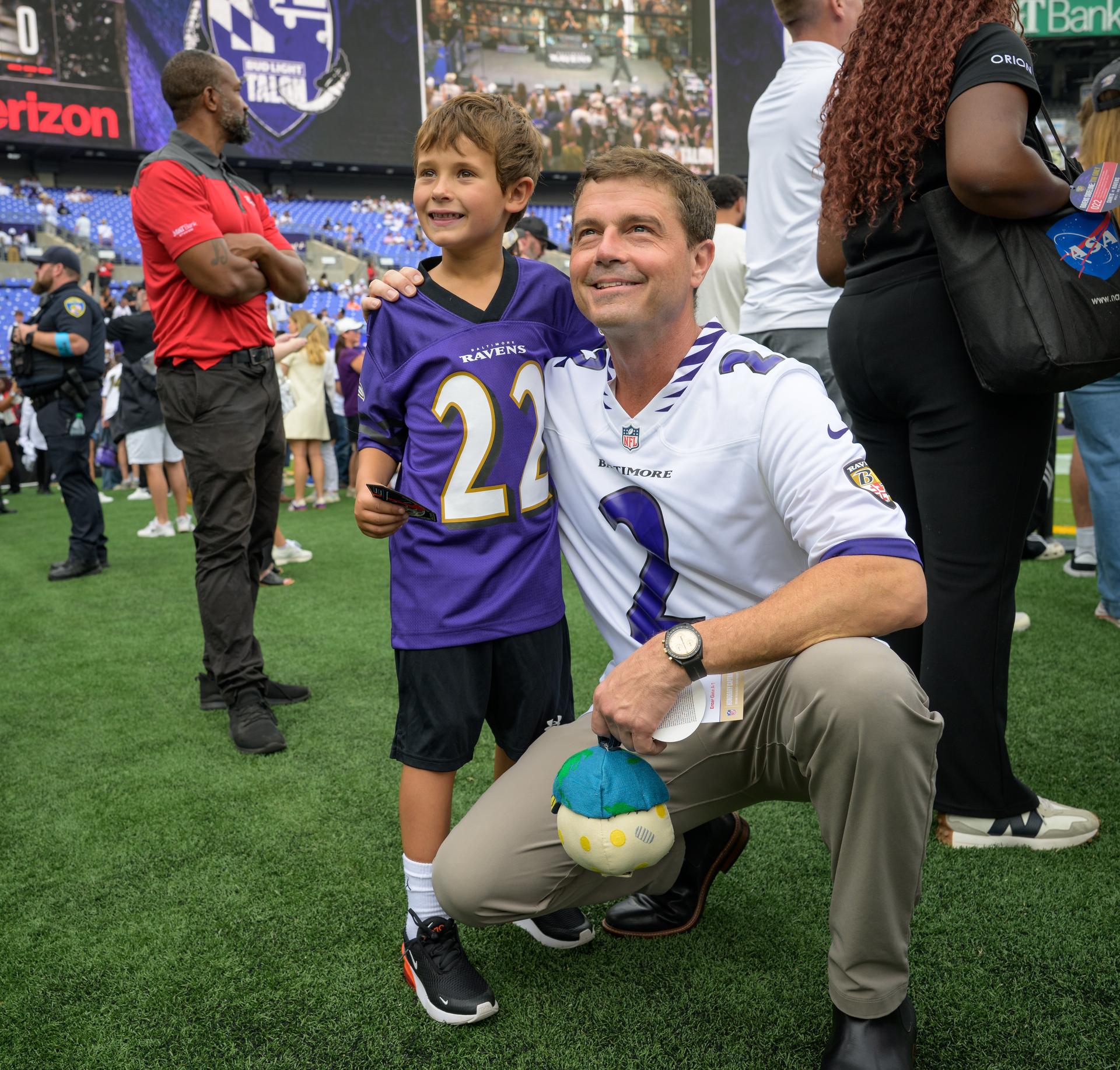 NASA astronaut and commander of the agency’s Artemis II mission, Reid Wiseman, a Baltimore native, poses for a photoraph with a fan while holding Rise, the zero gravity indicator from the Artemis II mission, at an NFL game between the New Orleans Saints and the Baltimore Ravens at M&T Bank Stadium, Sunday, Sept. 20, 2026, in Baltimore. NASA’s engagement at NFL games is part of the agency's Inspiration Tour, aimed at strengthening connections between NASA and its partners and showcasing innovation in air and space in the lead up to the MAX POWER aerospace technology expo and airshow at the agency's Kennedy Space Center in early November. Photo Credit: (NASA/Bill Ingalls)